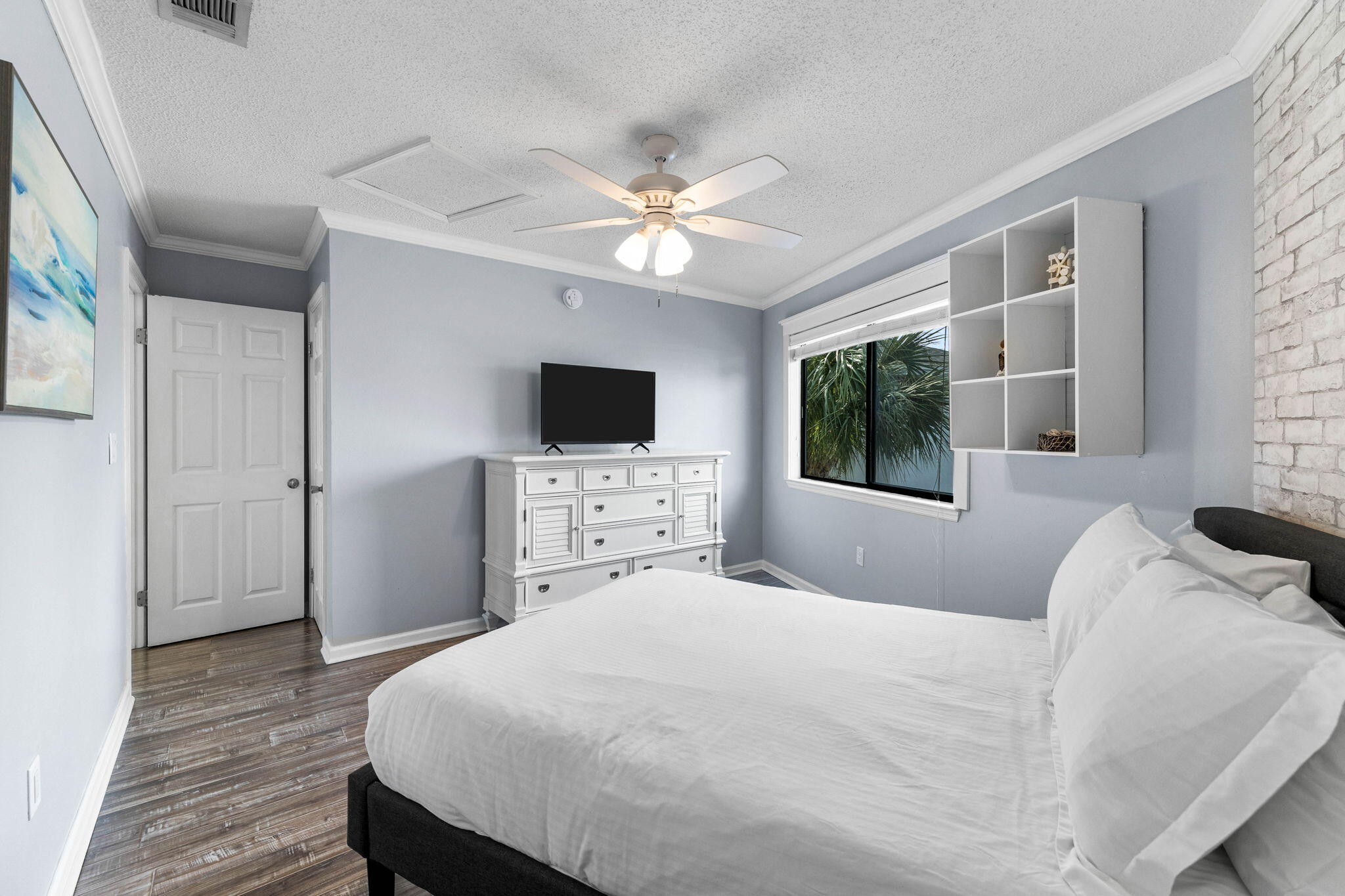 285 Payne Street, Unit 19B Destin, FL 32550 - Photo 18 of 29 a bedroom with a bed and a flat tv screen on dresser