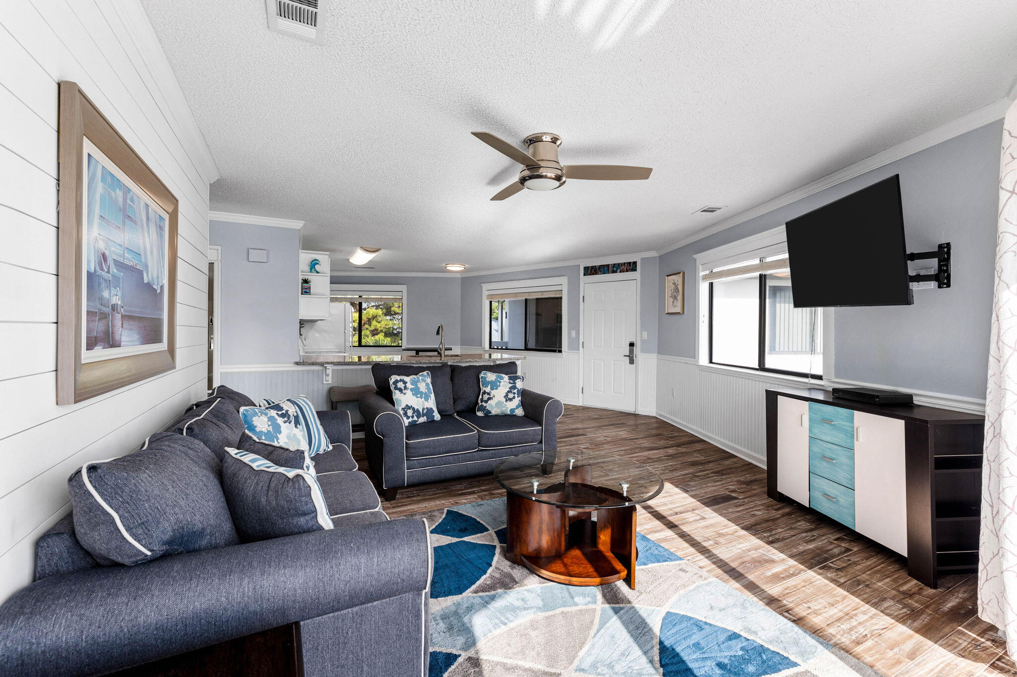 285 Payne Street, Unit 19B Destin, FL 32550 - Photo 4 of 29 a living room with furniture and a flat screen tv