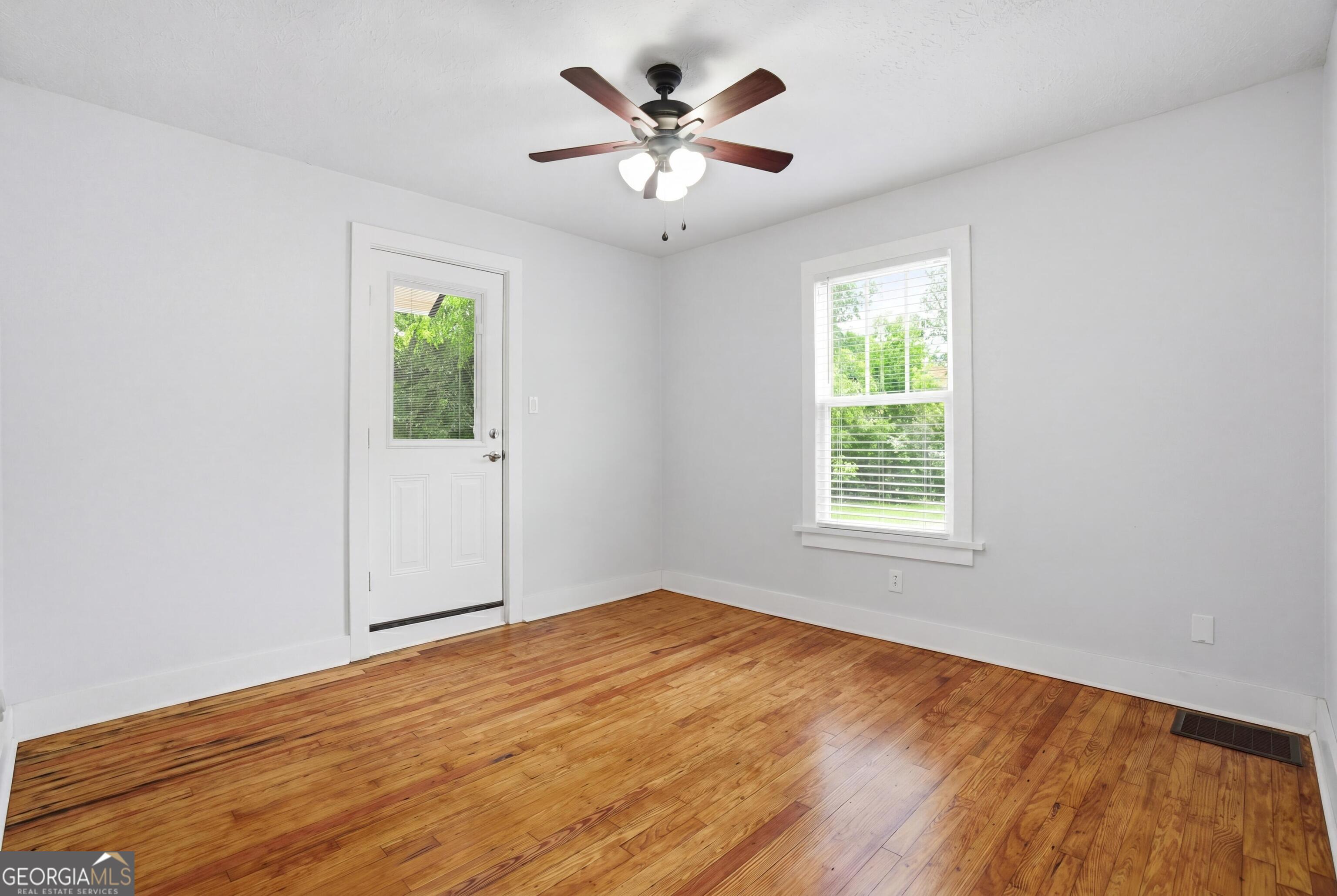 3022 Maple Road Southeast Lindale, GA 30147 - Photo 14 of 29 wooden floor in an empty room with a window