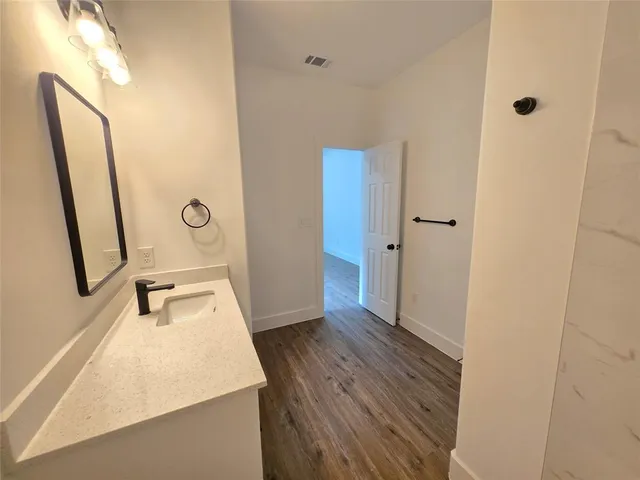 a bathroom with a sink a mirror and shower