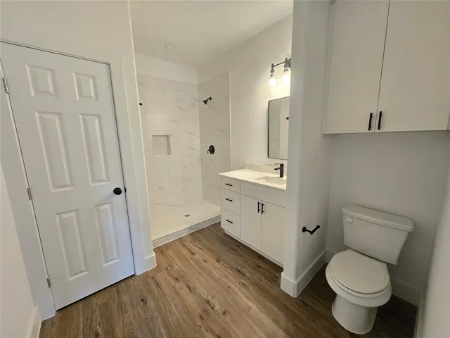 a bathroom with a toilet a sink and a mirror