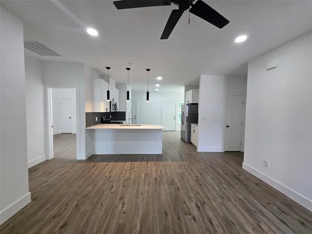 a large kitchen with cabinets and stainless steel appliances