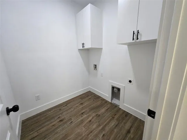 a view of storage and utility room with wooden floor