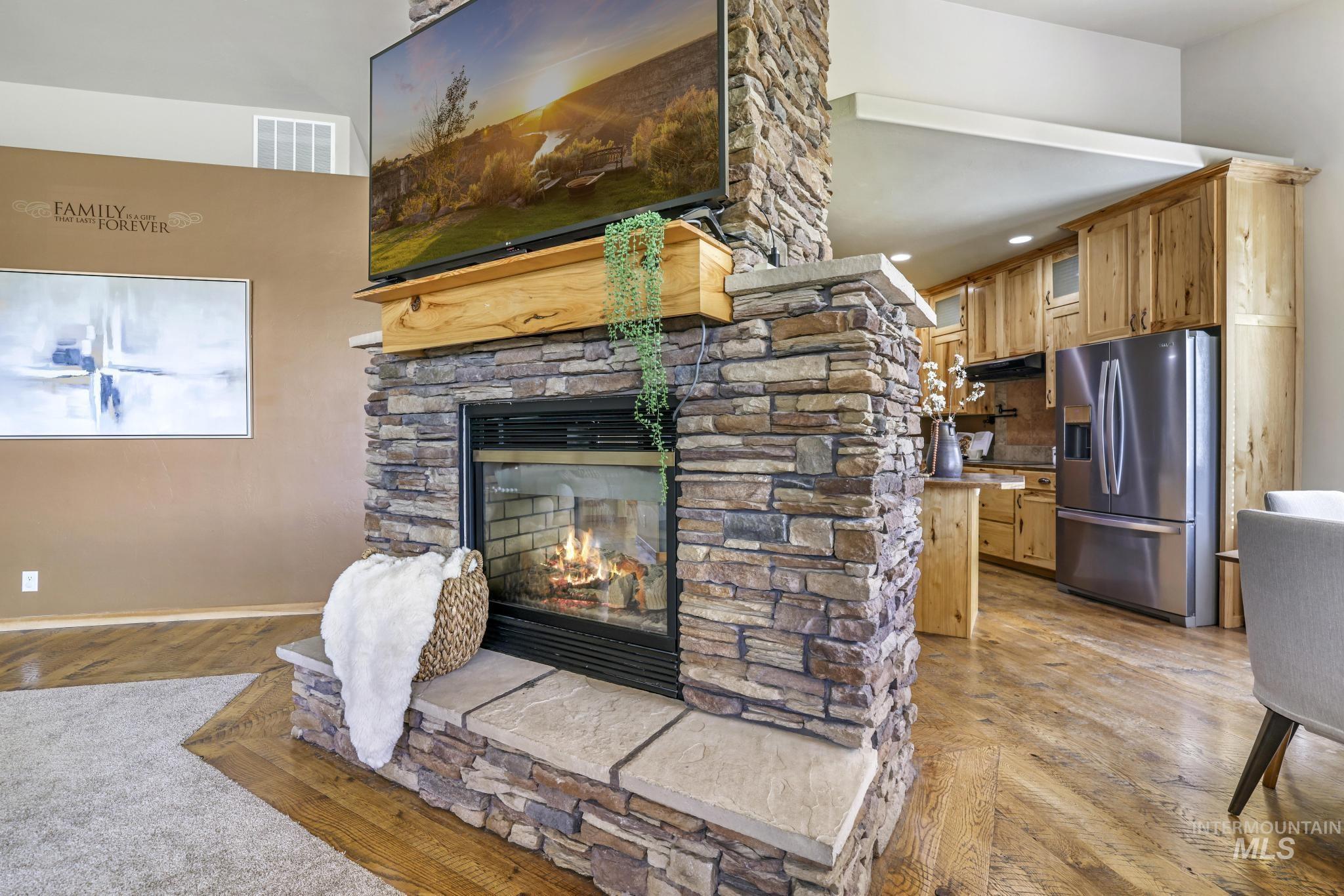 205 Edwards Drive Twin Falls, ID 83301 - Photo 11 of 49 Living area featuring a stone fireplace and light wood-type flooring