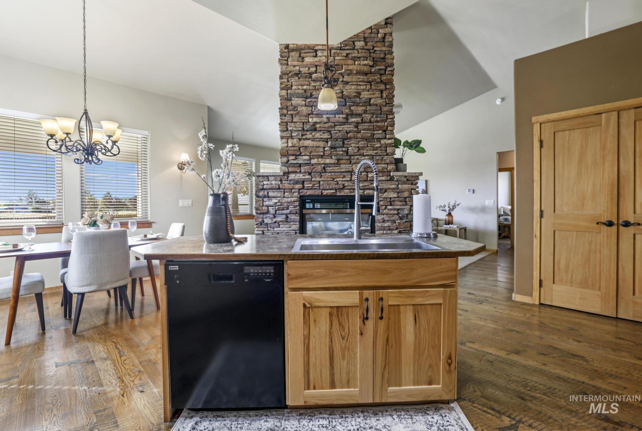 205 Edwards Drive Twin Falls, ID 83301 - Photo 49 of 49 Kitchen featuring dishwasher, dark wood-style flooring, open floor plan, pendant lighting, and high vaulted ceiling
