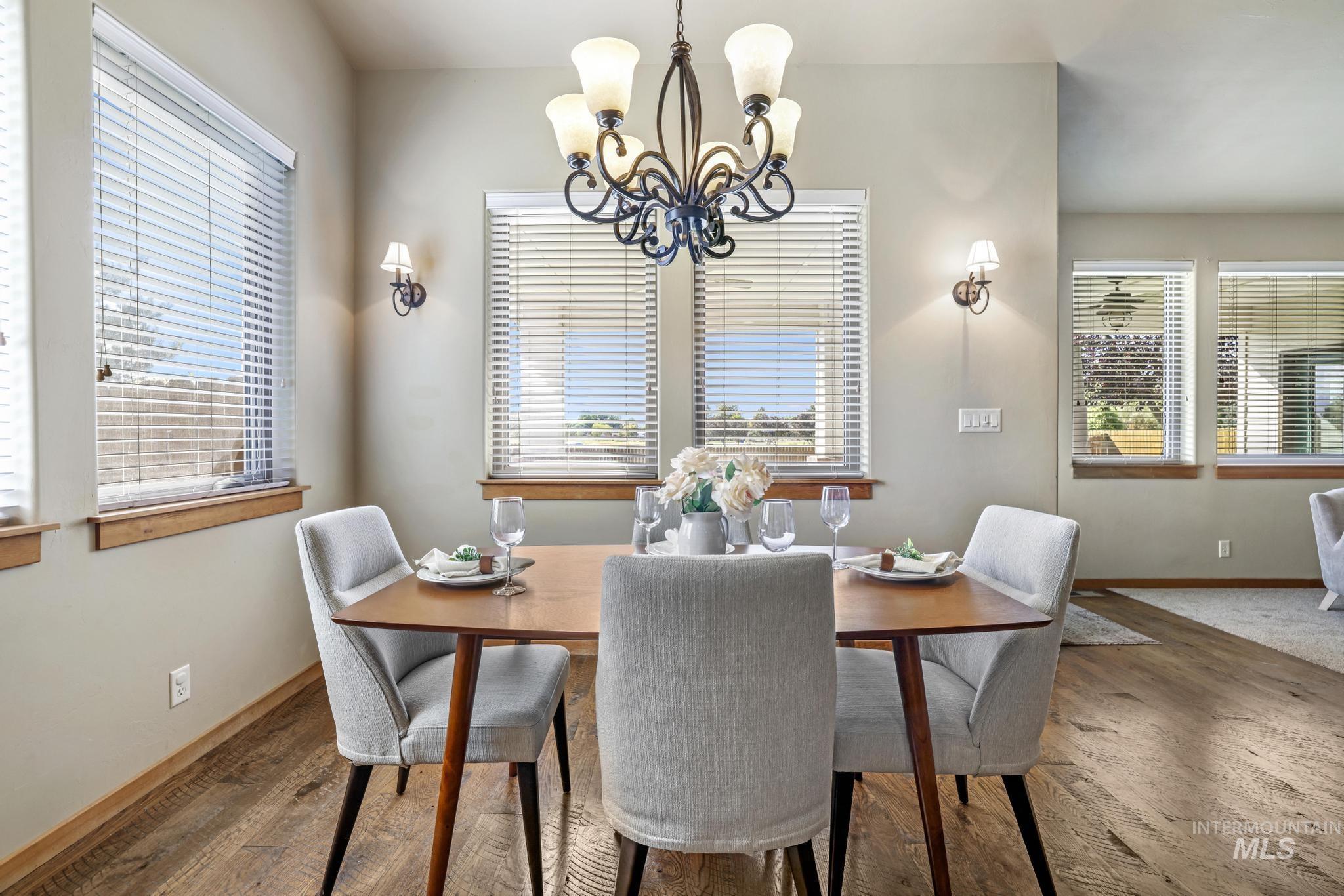 205 Edwards Drive Twin Falls, ID 83301 - Photo 18 of 49 Dining area featuring dark wood-style flooring and a chandelier