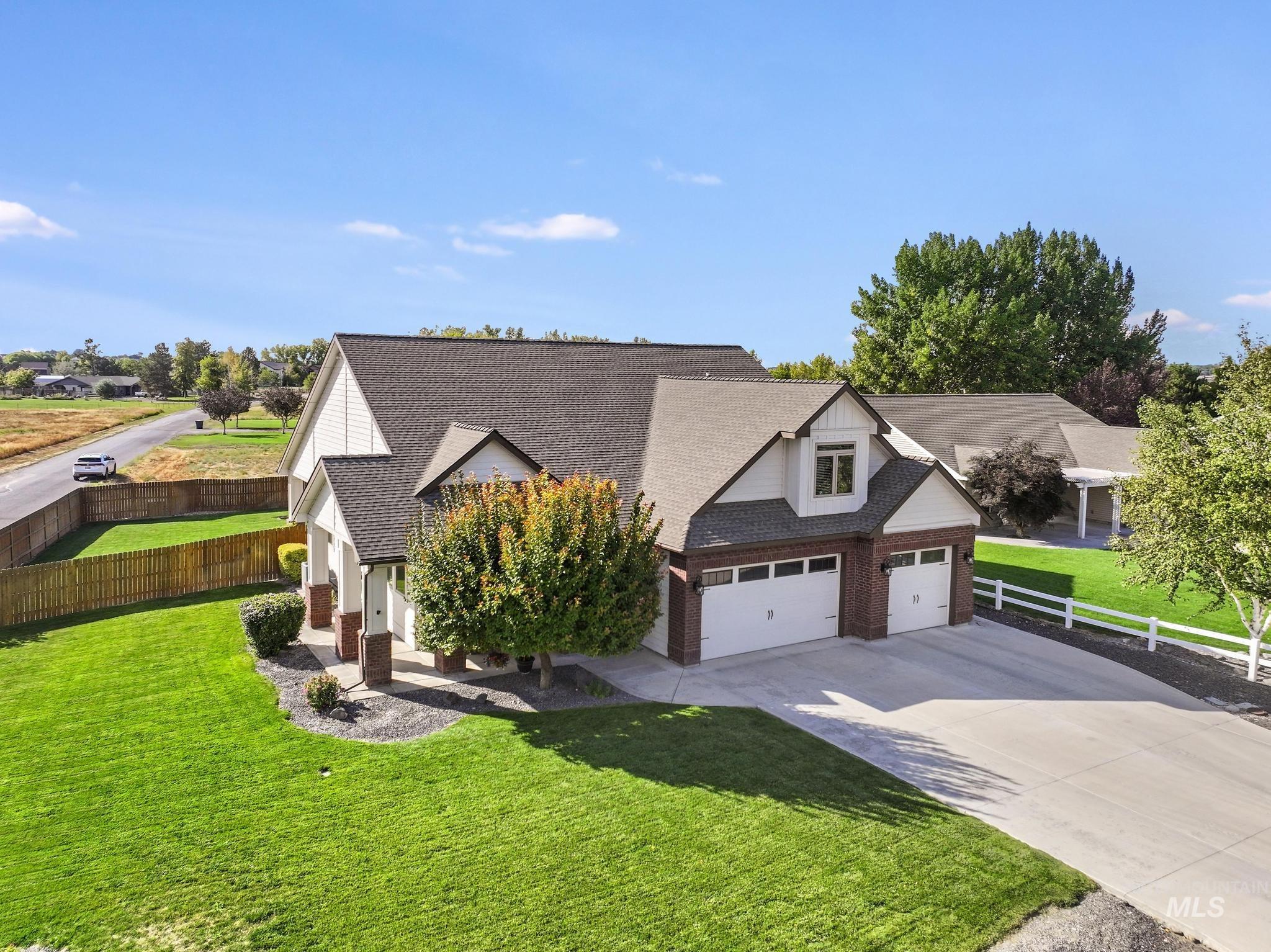 205 Edwards Drive Twin Falls, ID 83301 - Photo 2 of 49 View of front of home with driveway, a shingled roof, and brick siding