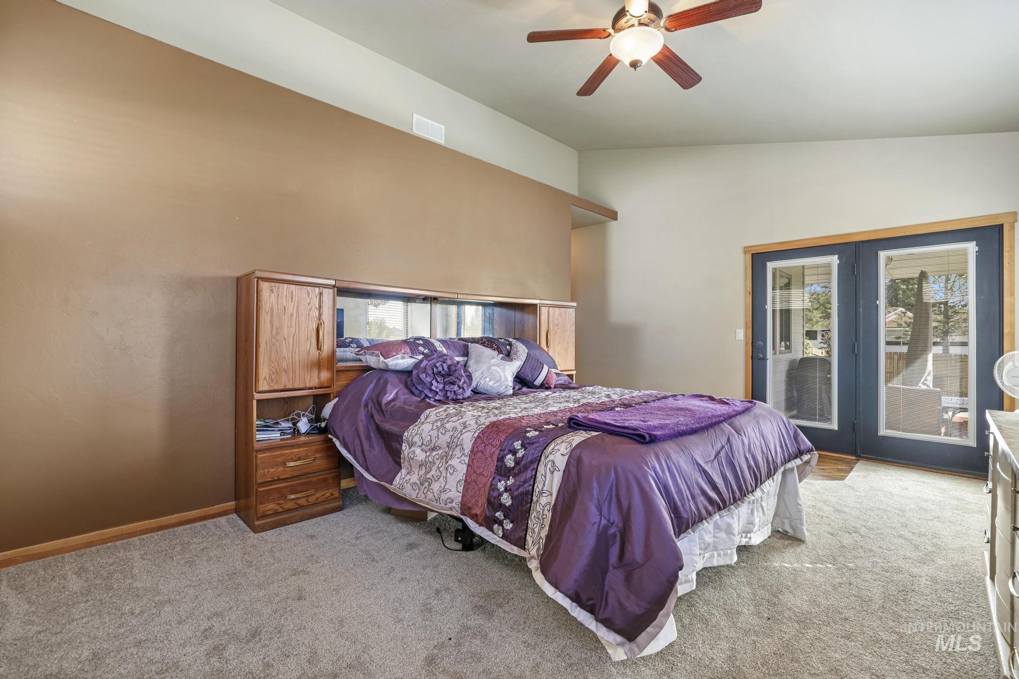 205 Edwards Drive Twin Falls, ID 83301 - Photo 21 of 49 Carpeted bedroom with access to exterior, vaulted ceiling, and a ceiling fan