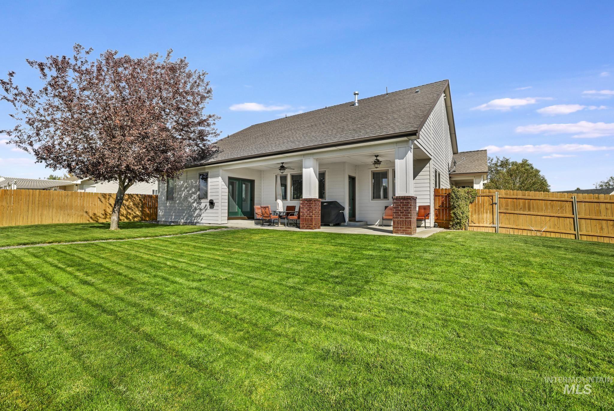 205 Edwards Drive Twin Falls, ID 83301 - Photo 38 of 49 Rear view of property with ceiling fan, a fenced backyard, a patio, and roof with shingles