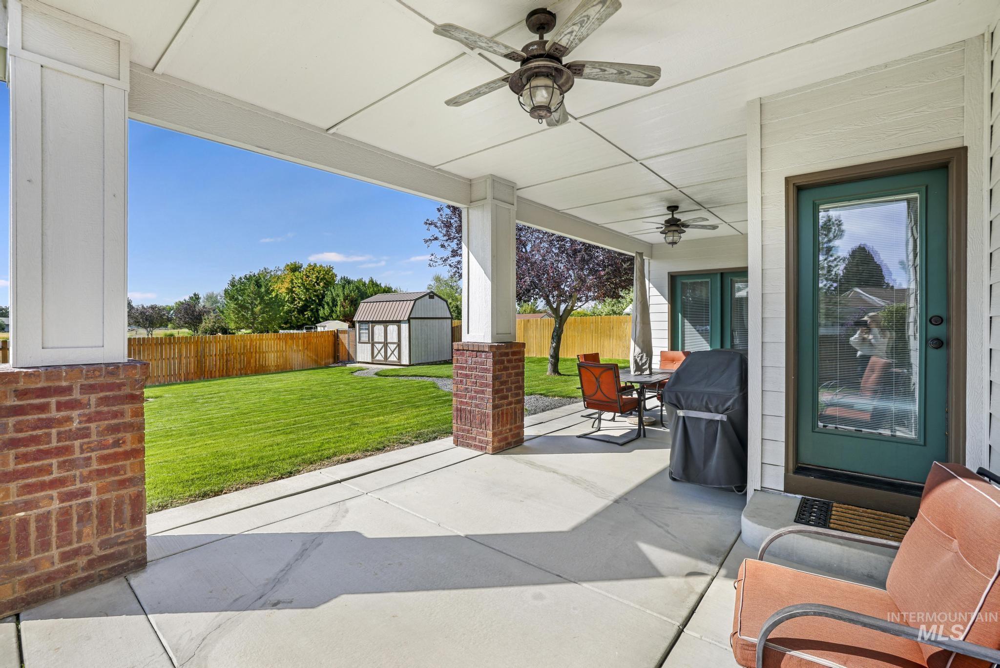 205 Edwards Drive Twin Falls, ID 83301 - Photo 39 of 49 Fenced backyard featuring a patio area, a storage unit, area for grilling, outdoor dining space, and ceiling fan