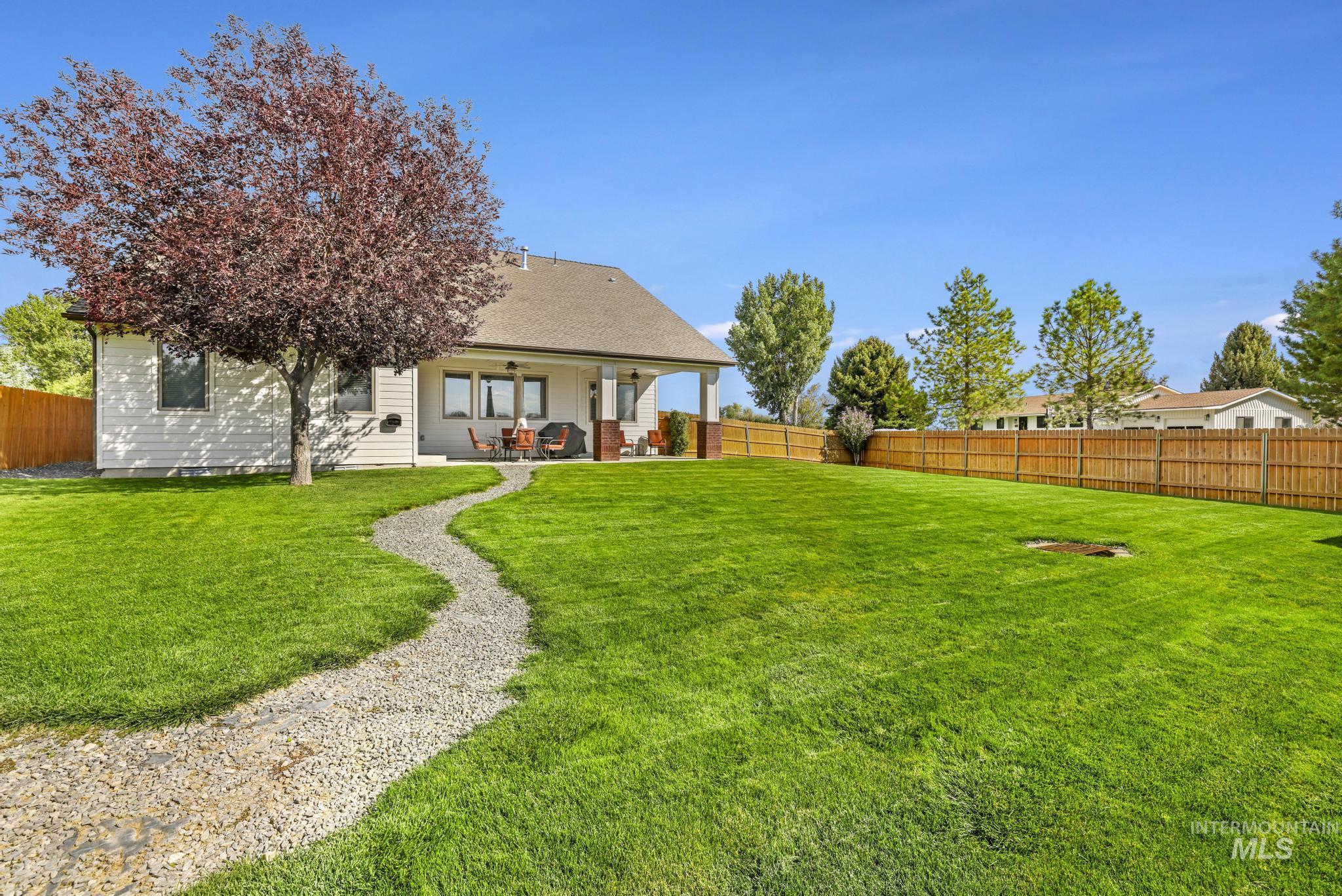 205 Edwards Drive Twin Falls, ID 83301 - Photo 41 of 49 Rear view of house featuring a fenced backyard, a patio, and roof with shingles
