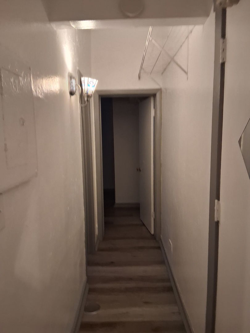 3920 North Broadway, Unit 202 Chicago, IL 60613 - Photo 4 of 7 a view of a hallway with wooden floor and entryway