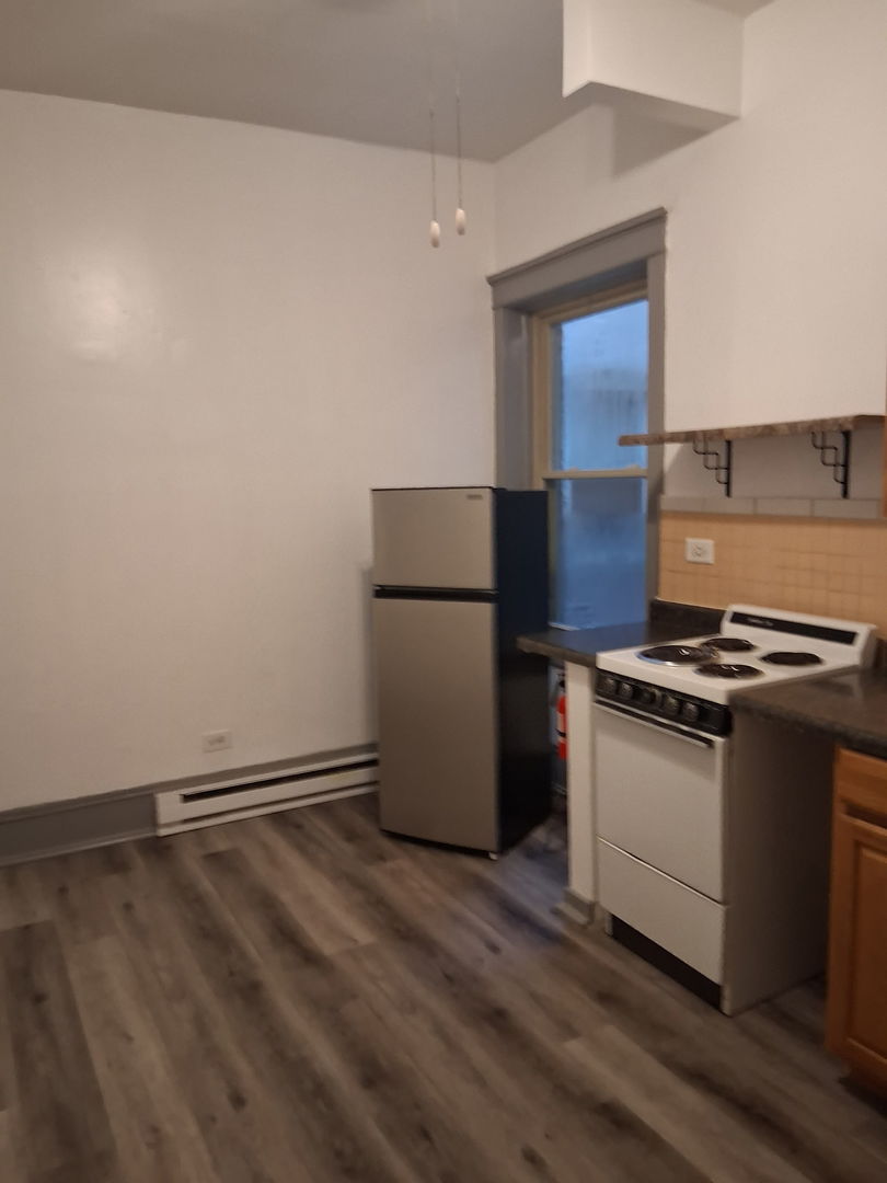 3920 North Broadway, Unit 202 Chicago, IL 60613 - Photo 7 of 7 a kitchen with a refrigerator and a stove