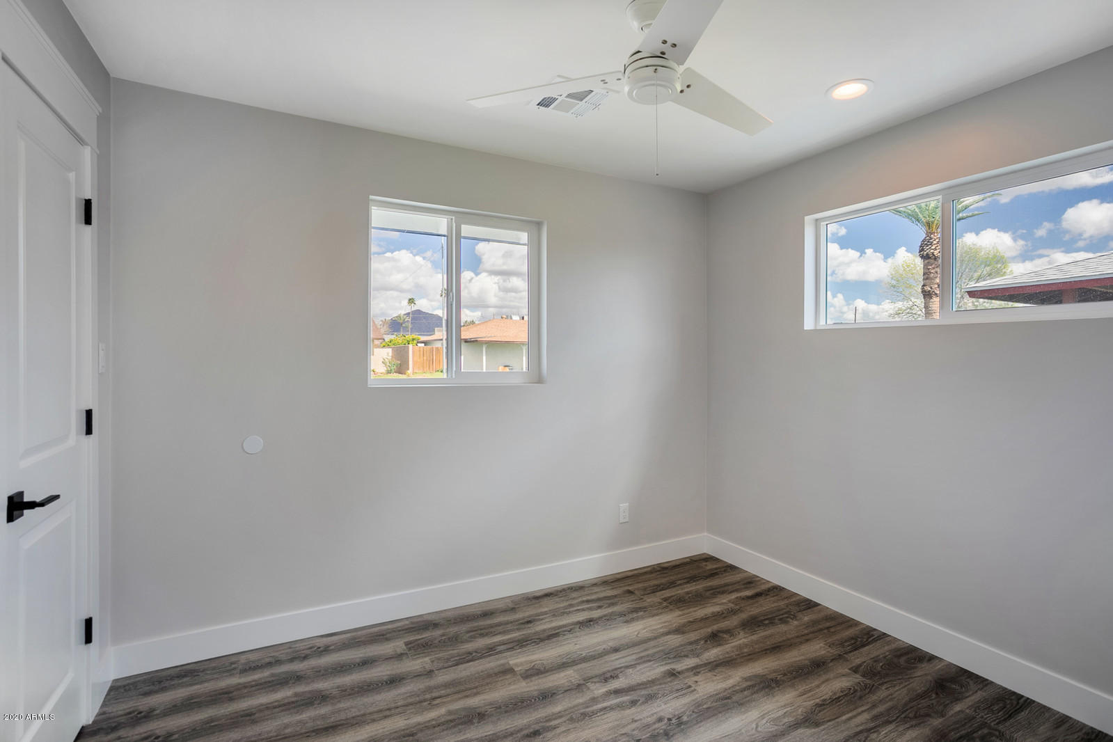 4917 East Granada Road Phoenix, AZ 85008 - Photo 12 of 18 a view of an empty room with wooden floor and a window