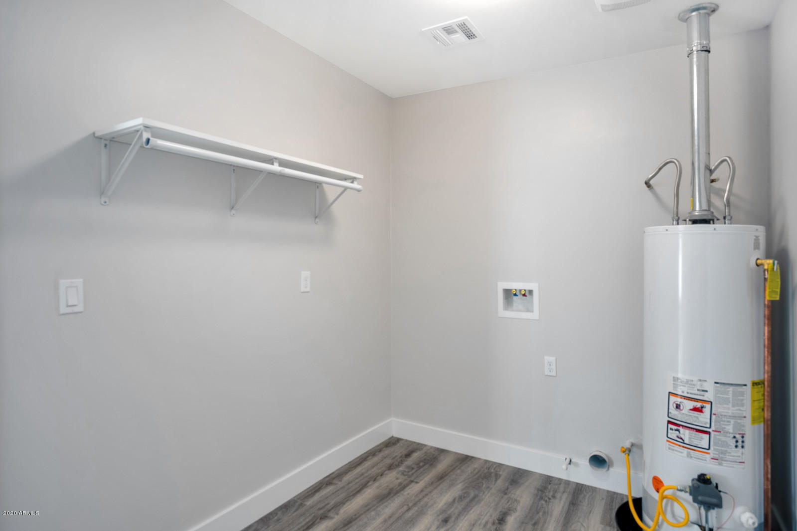 4917 East Granada Road Phoenix, AZ 85008 - Photo 15 of 18 a view of storage and utility room with wooden floor