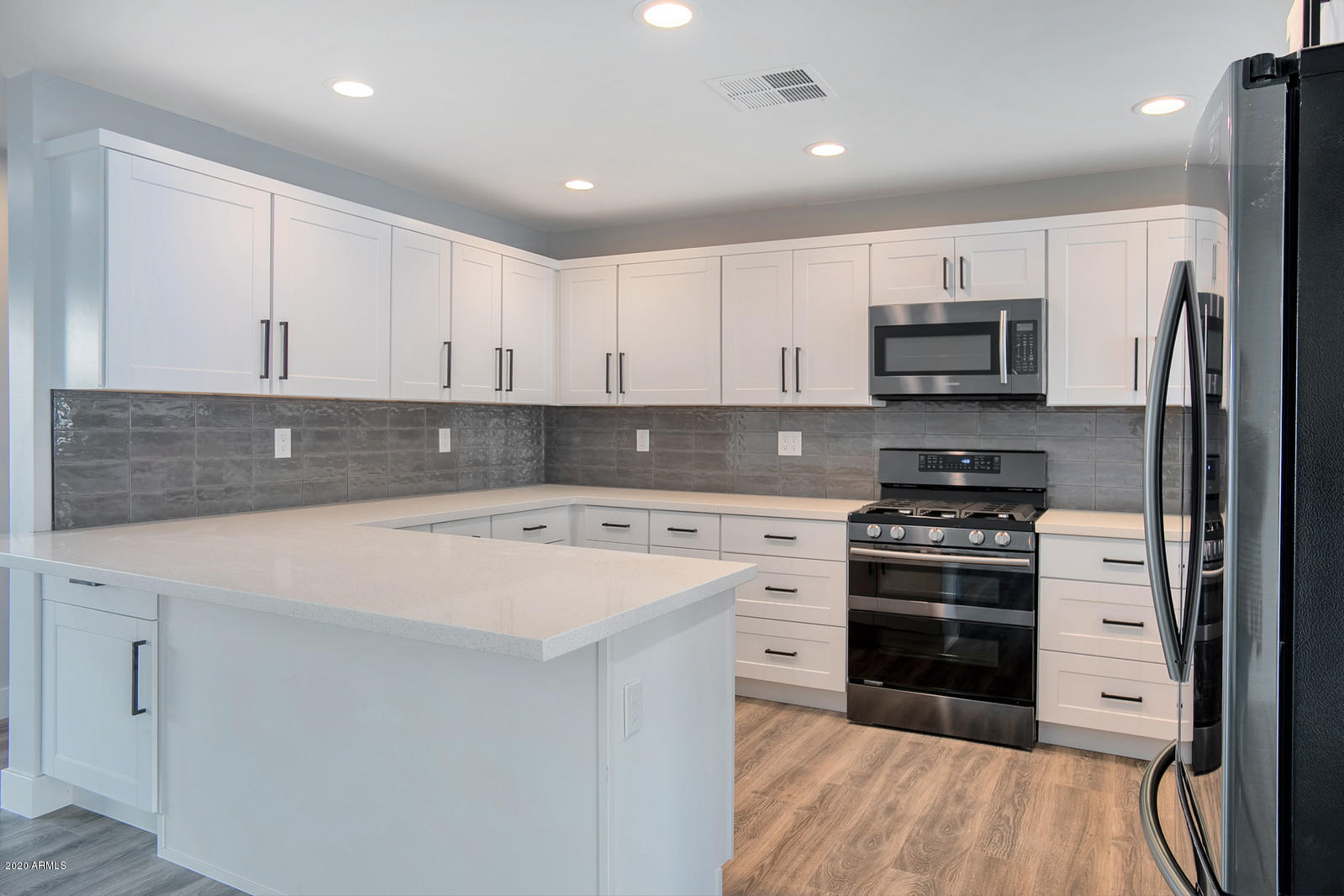 4917 East Granada Road Phoenix, AZ 85008 - Photo 4 of 18 a kitchen with stainless steel appliances a stove sink and microwave
