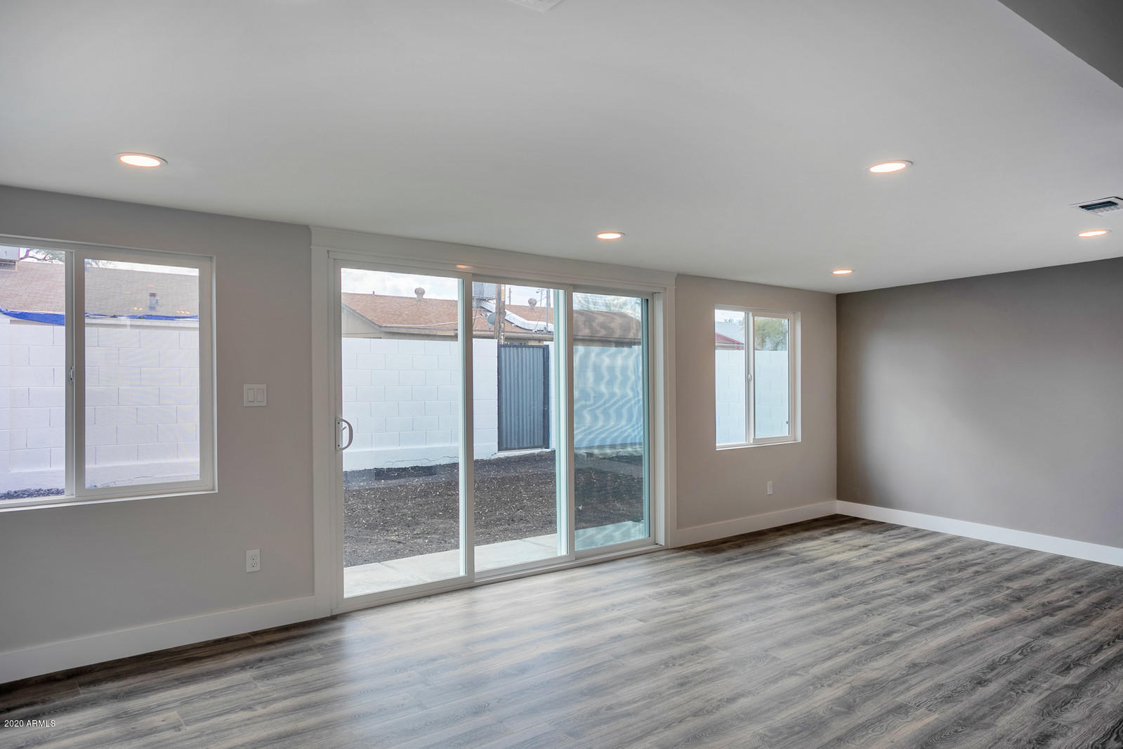 4917 East Granada Road Phoenix, AZ 85008 - Photo 7 of 18 a view of an empty room with wooden floor and a window