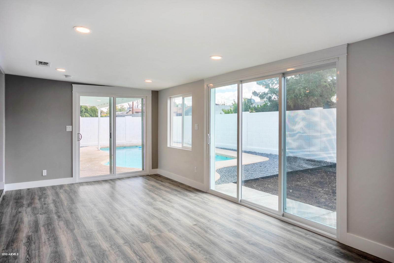 4917 East Granada Road Phoenix, AZ 85008 - Photo 8 of 18 a view of an empty room with wooden floor and a window