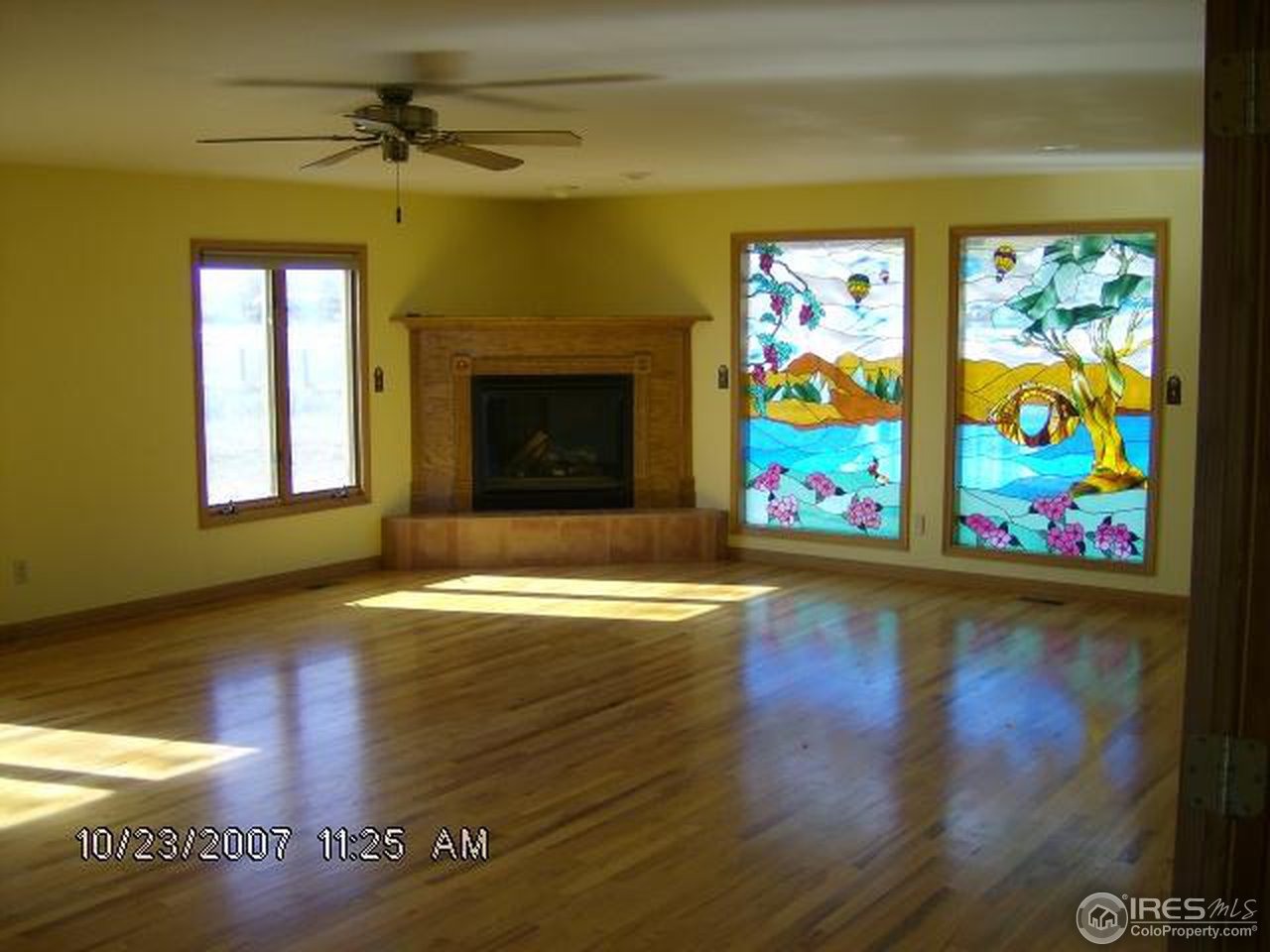 2504 South Brehm Road Berthoud, CO 80513 - Photo 6 of 8 a view of empty room with window and fireplace