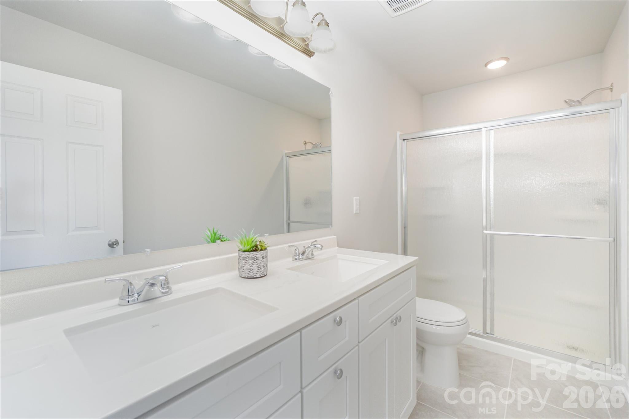 2133 Tom Sadler Road Charlotte, NC 28214 - Photo 16 of 30 a bathroom with a sink a toilet and shower