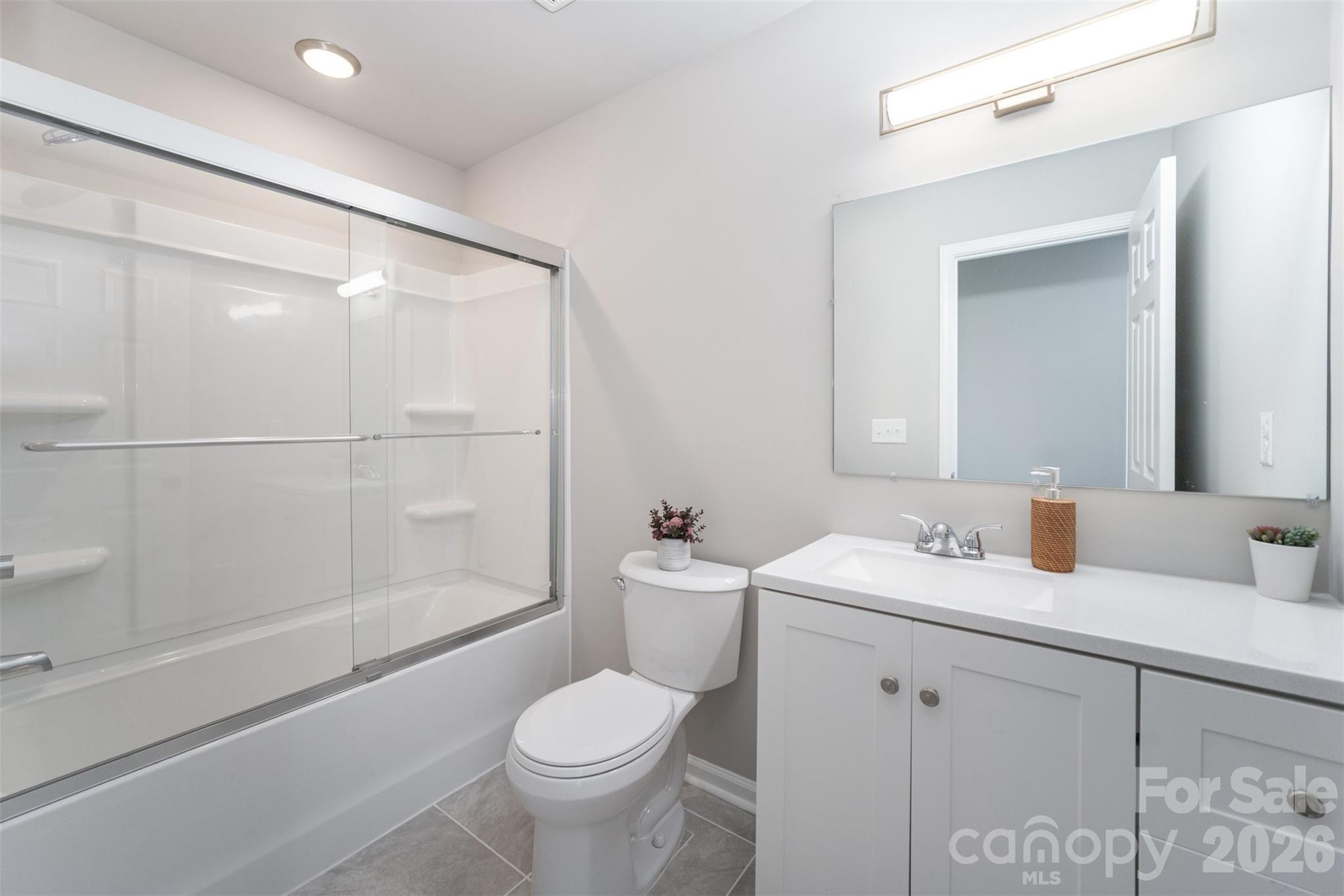 2133 Tom Sadler Road Charlotte, NC 28214 - Photo 18 of 30 a bathroom with a sink toilet vanity and shower