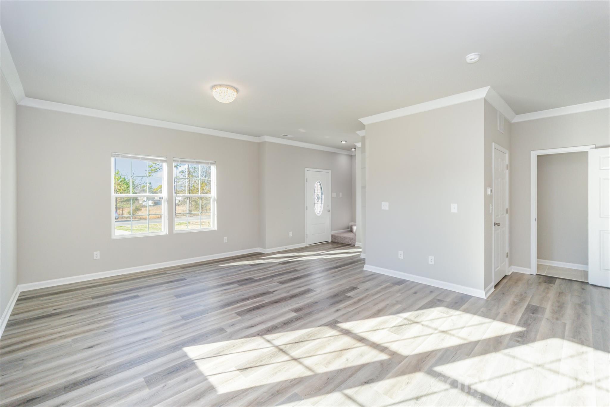 2133 Tom Sadler Road Charlotte, NC 28214 - Photo 2 of 30 a view of an empty room and window and wooden floor