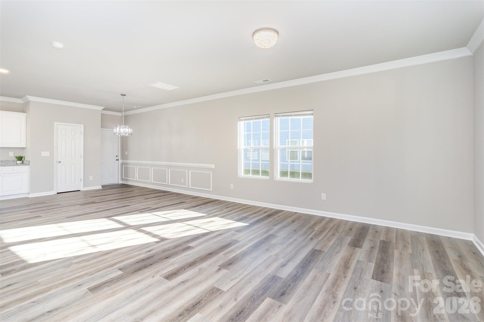 2133 Tom Sadler Road Charlotte, NC 28214 - Photo 3 of 30 an empty room with wooden floor and windows