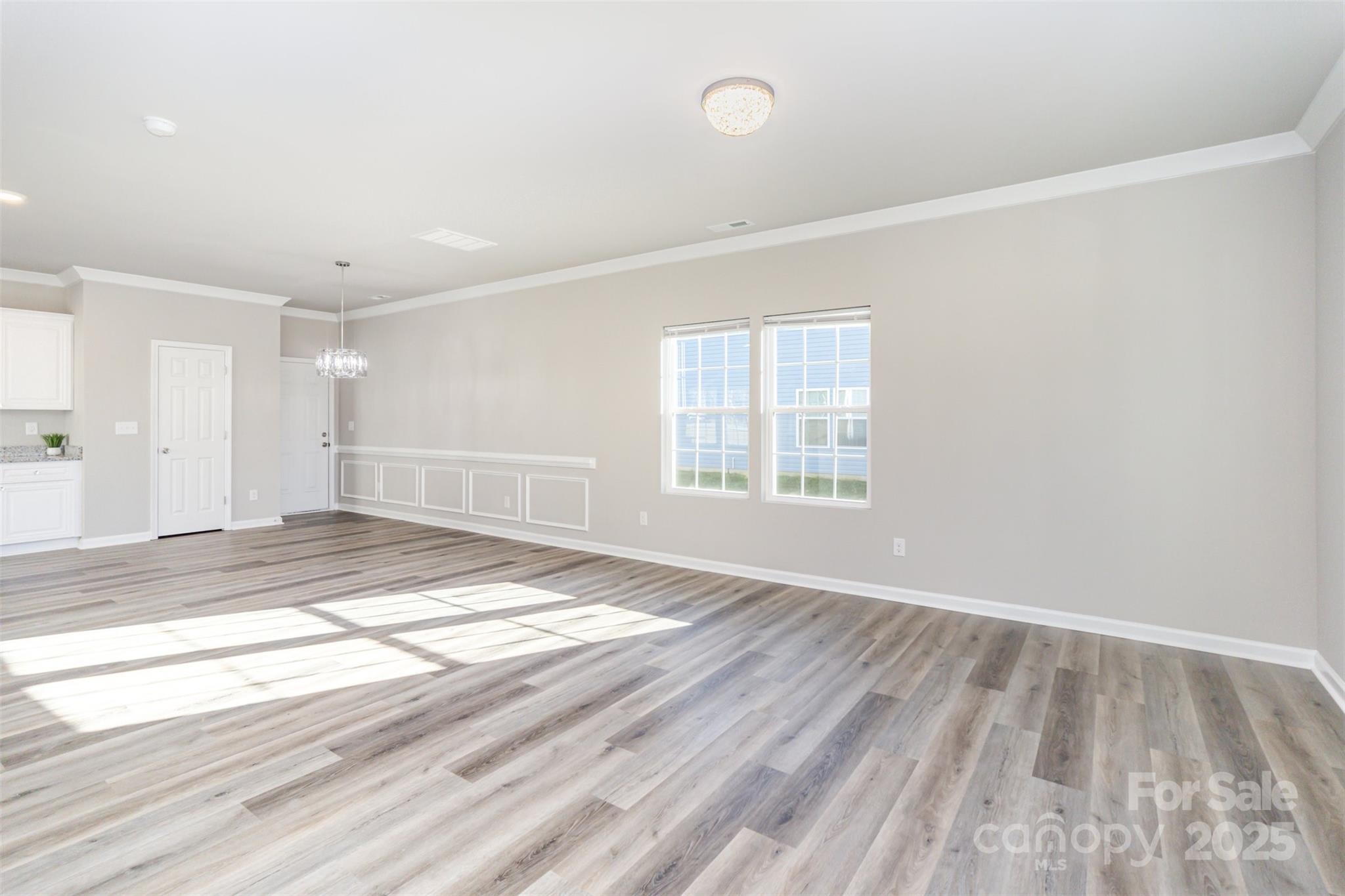 2133 Tom Sadler Road Charlotte, NC 28214 - Photo 5 of 27 an empty room with wooden floor and windows