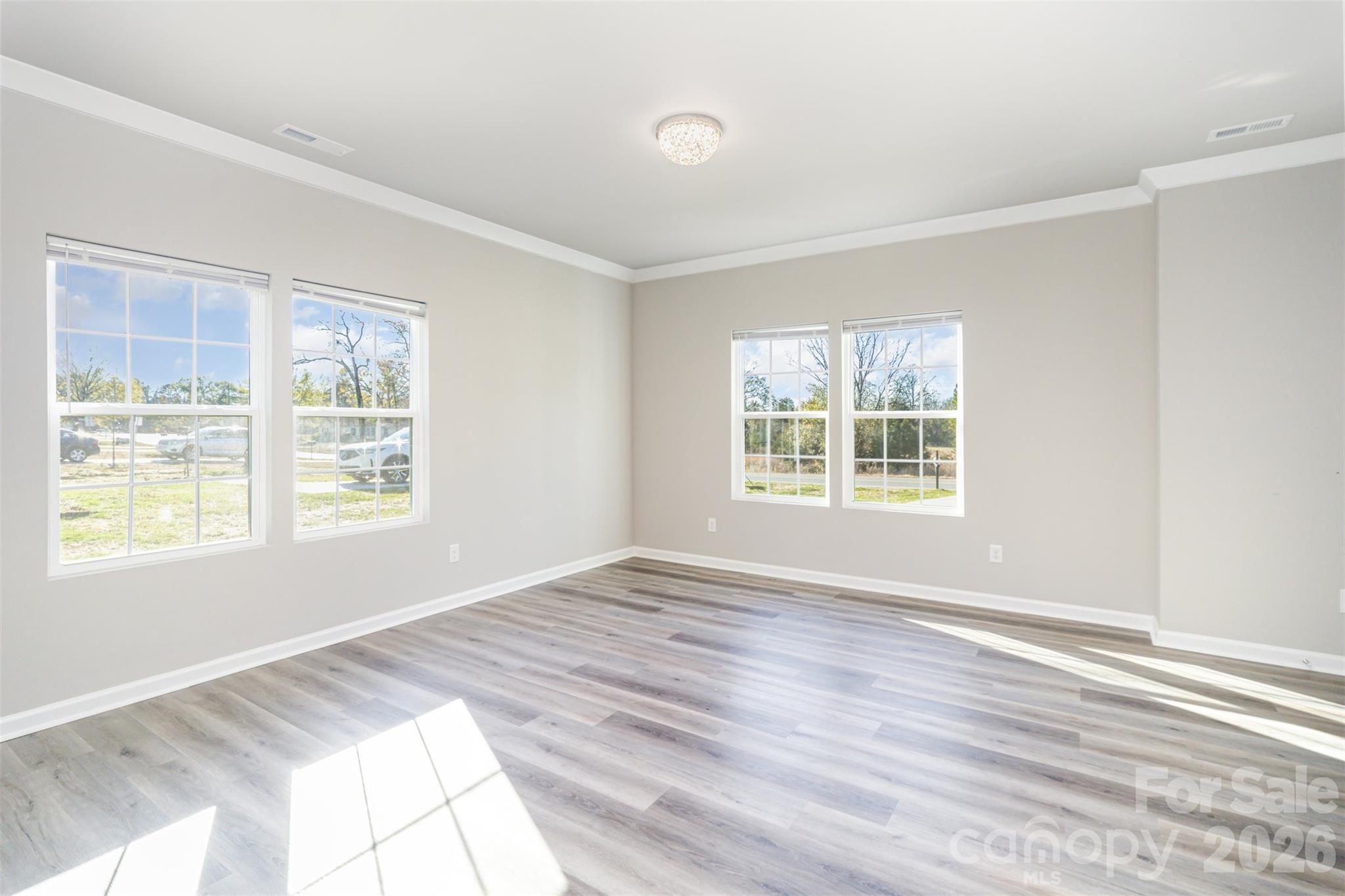 2133 Tom Sadler Road Charlotte, NC 28214 - Photo 5 of 30 a view of an empty room with wooden floor and a window