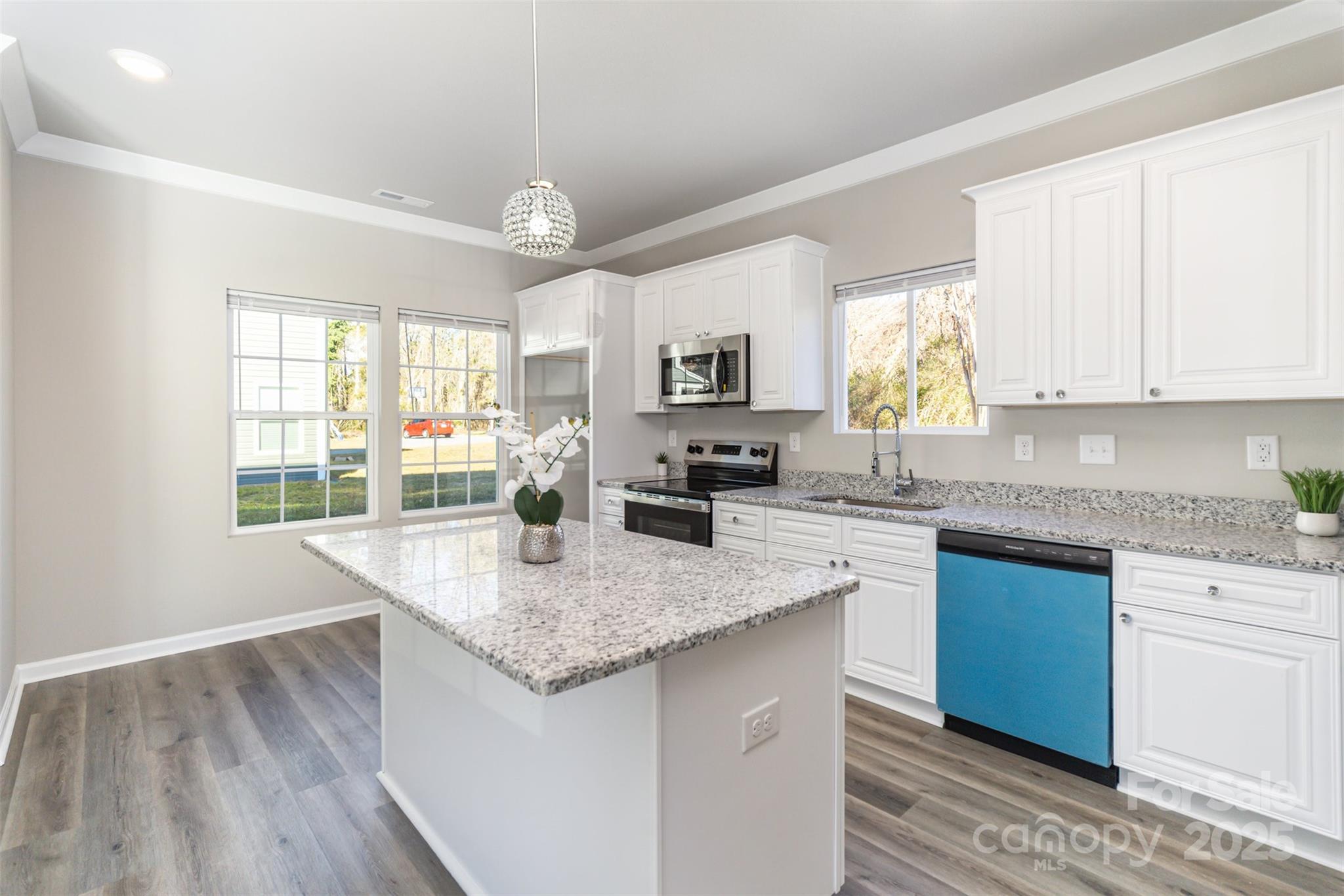 2133 Tom Sadler Road Charlotte, NC 28214 - Photo 6 of 27 a kitchen with granite countertop kitchen island a sink stove and cabinets