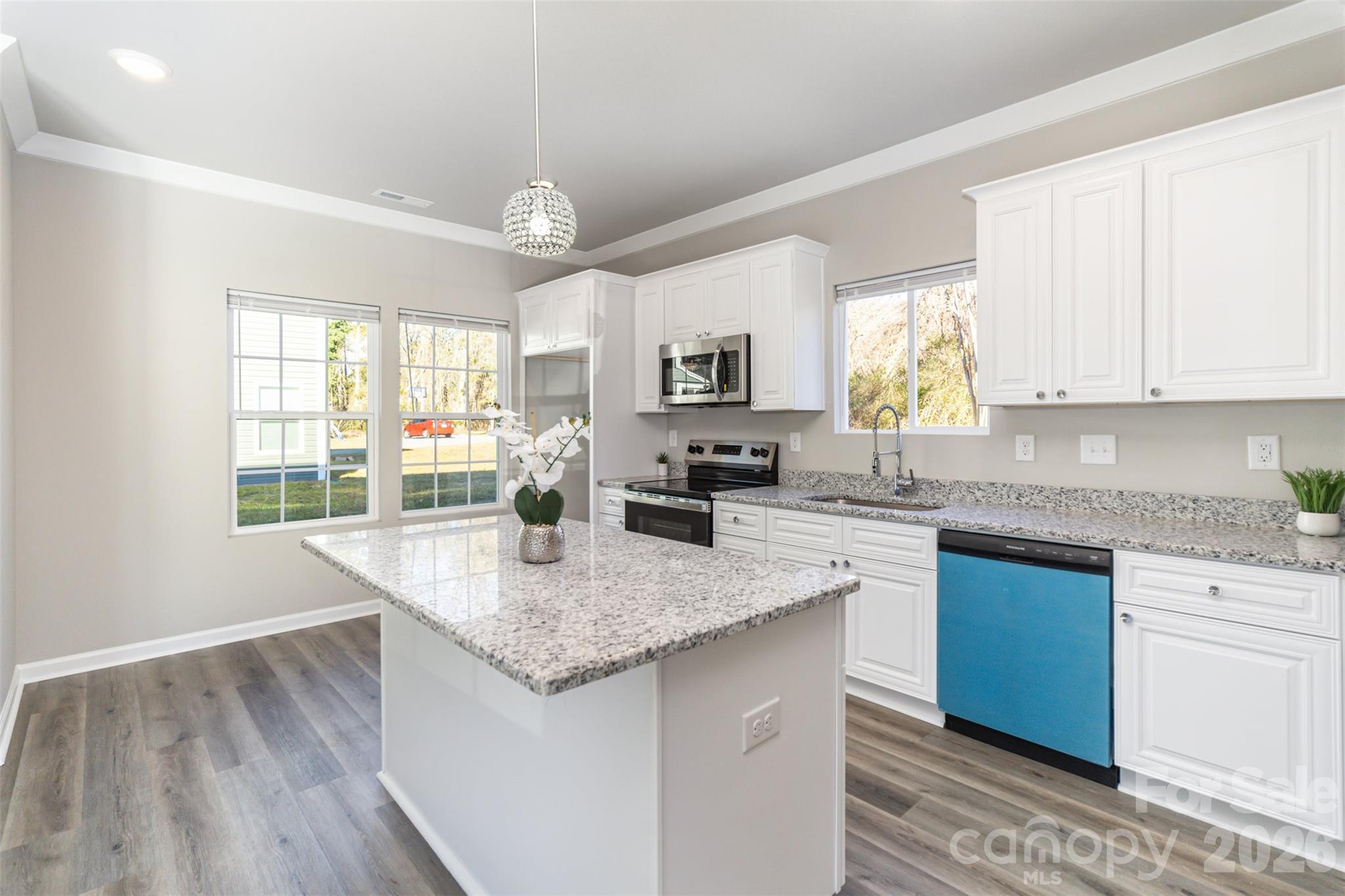 2133 Tom Sadler Road Charlotte, NC 28214 - Photo 8 of 30 a kitchen with granite countertop kitchen island a sink stove and cabinets