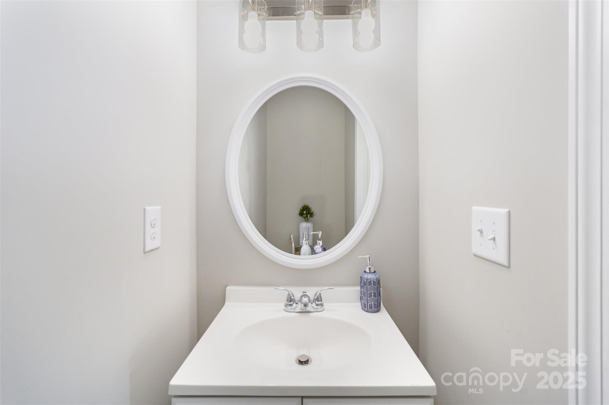 2133 Tom Sadler Road Charlotte, NC 28214 - Photo 10 of 27 a bathroom with a sink mirror and vanity