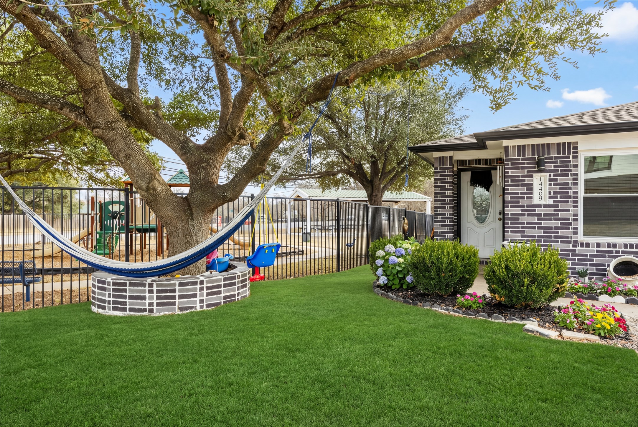 14409 Sandifer Street Austin, TX 78725 - Photo 2 of 31 View of yard with a playground. Grass Virtually Enhanced.