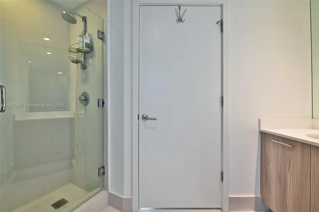 a bathroom with a glass shower door