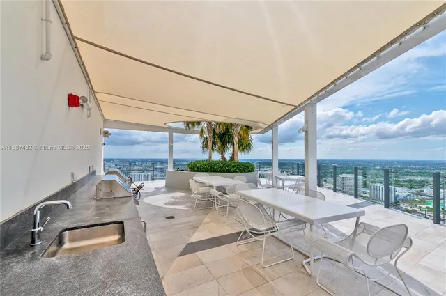 a view of a patio with a table and chairs