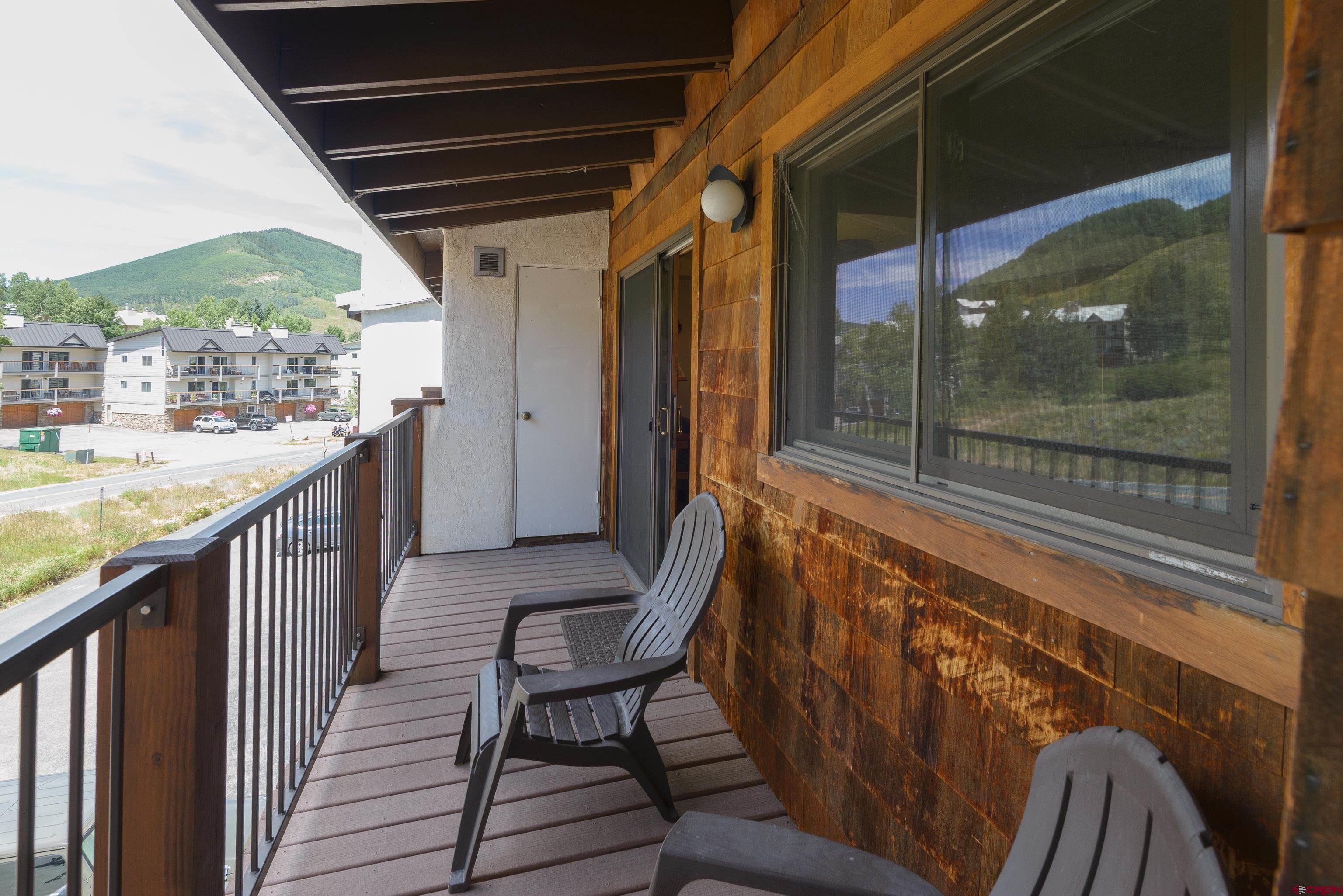 701 Gothic Road, Unit 332 Crested Butte, CO 81225 - Photo 12 of 29 a view of a chairs and table in the balcony