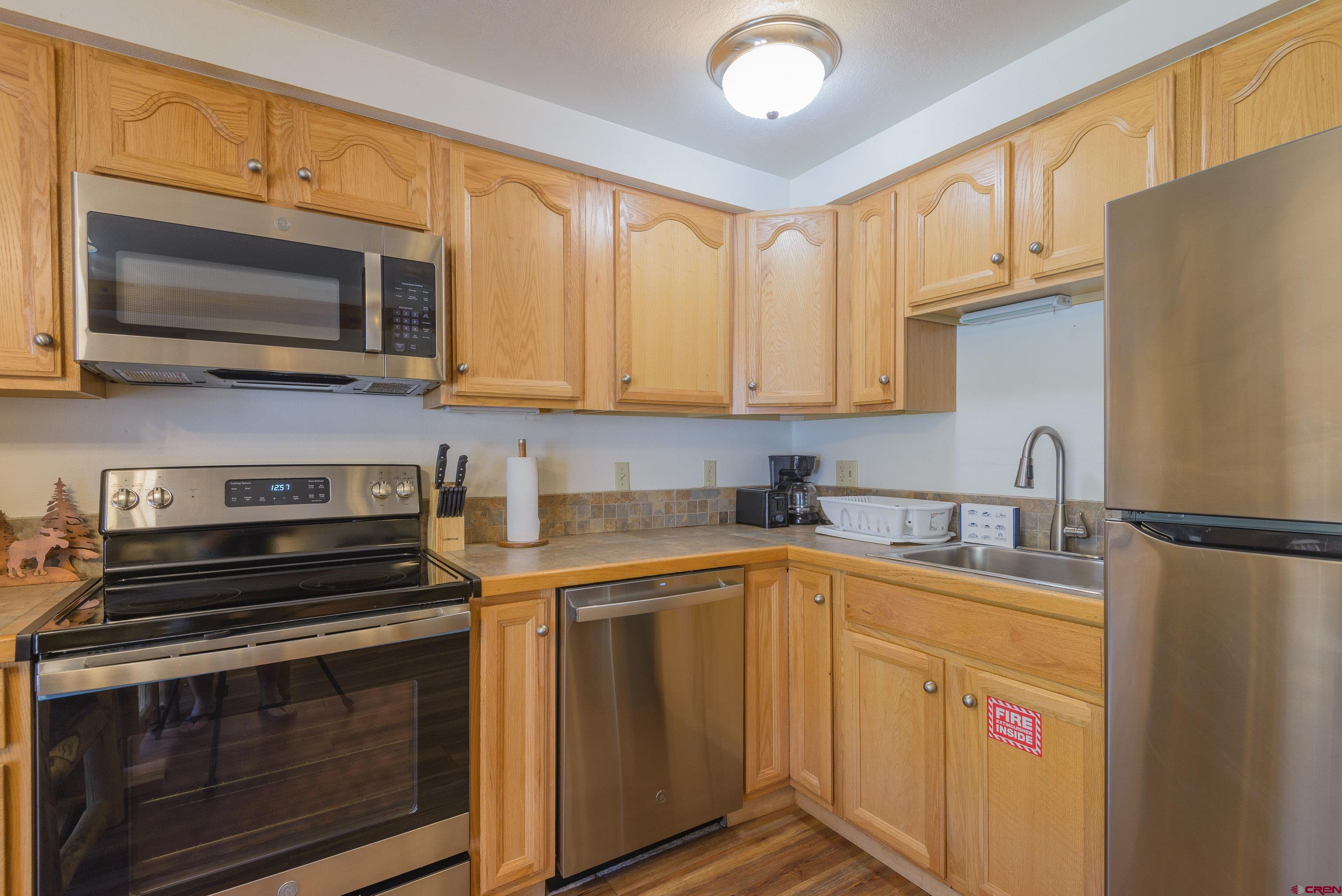 701 Gothic Road, Unit 332 Crested Butte, CO 81225 - Photo 14 of 29 a kitchen with stainless steel appliances a stove microwave and sink