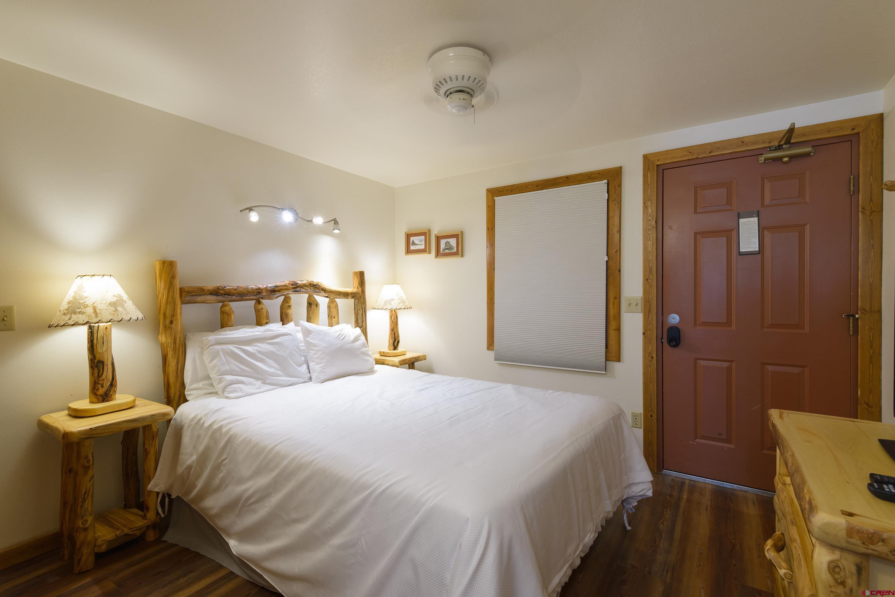 701 Gothic Road, Unit 332 Crested Butte, CO 81225 - Photo 15 of 29 a bedroom with a bed and a lamp