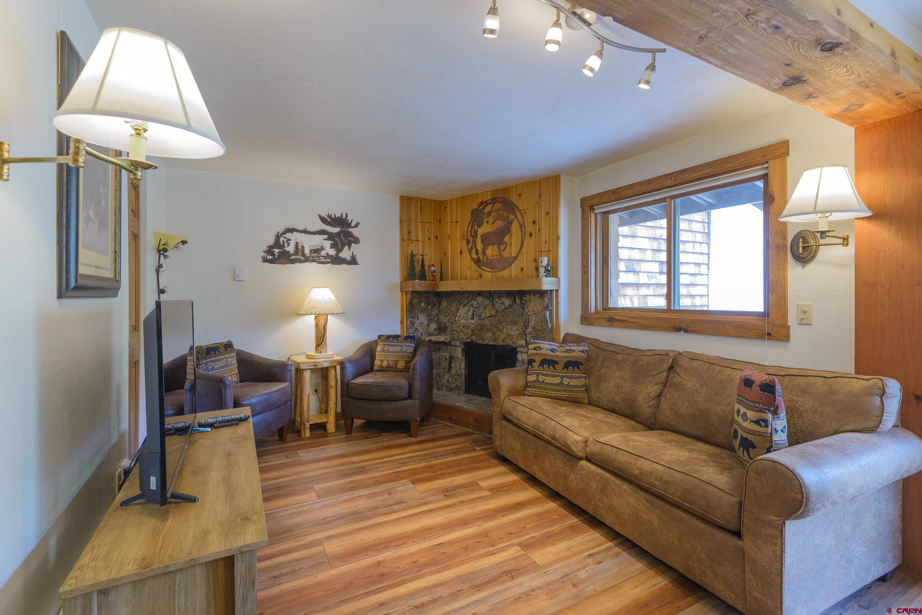 701 Gothic Road, Unit 332 Crested Butte, CO 81225 - Photo 2 of 29 a living room with furniture and a fireplace