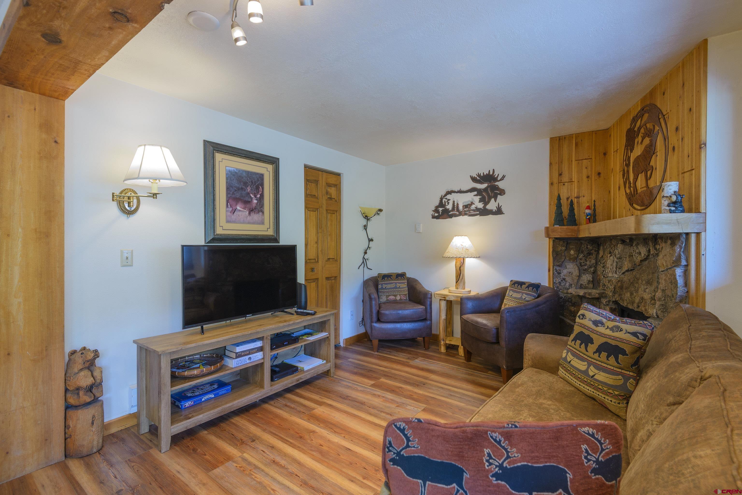 701 Gothic Road, Unit 332 Crested Butte, CO 81225 - Photo 22 of 29 a living room with furniture and a flat screen tv