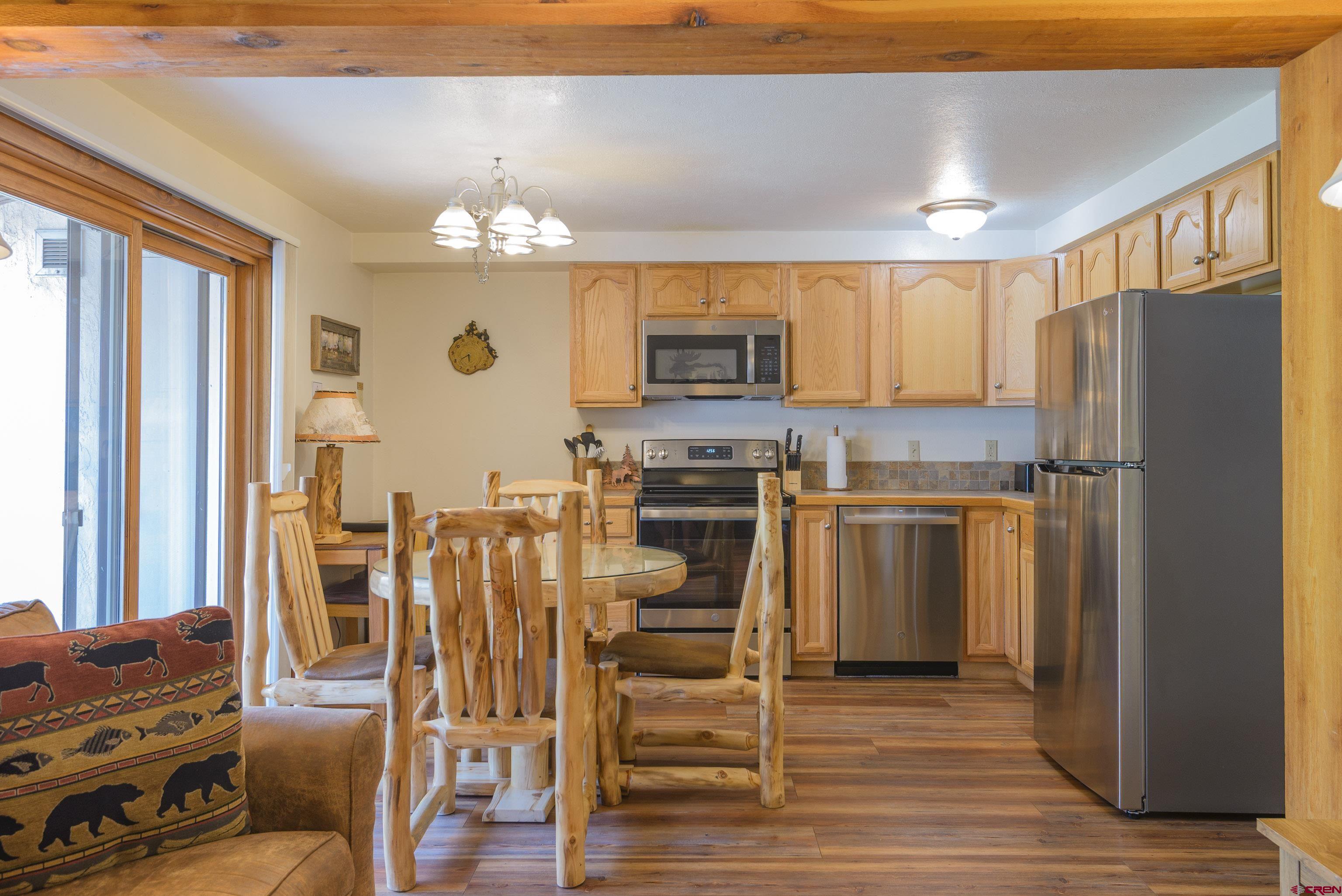 701 Gothic Road, Unit 332 Crested Butte, CO 81225 - Photo 23 of 29 a kitchen with a refrigerator cabinets and wooden floor