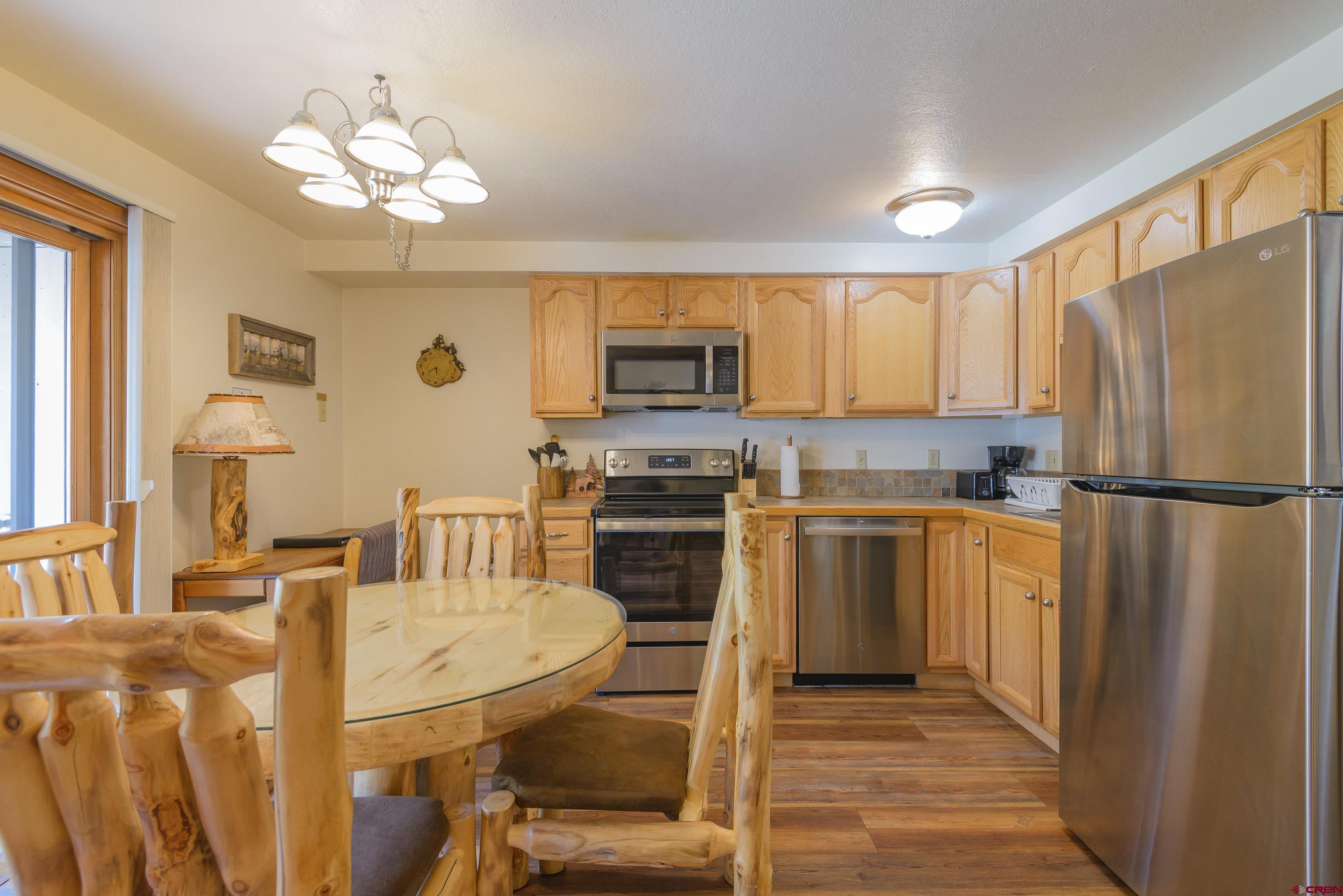701 Gothic Road, Unit 332 Crested Butte, CO 81225 - Photo 25 of 29 a kitchen with refrigerator cabinets and a stove top oven
