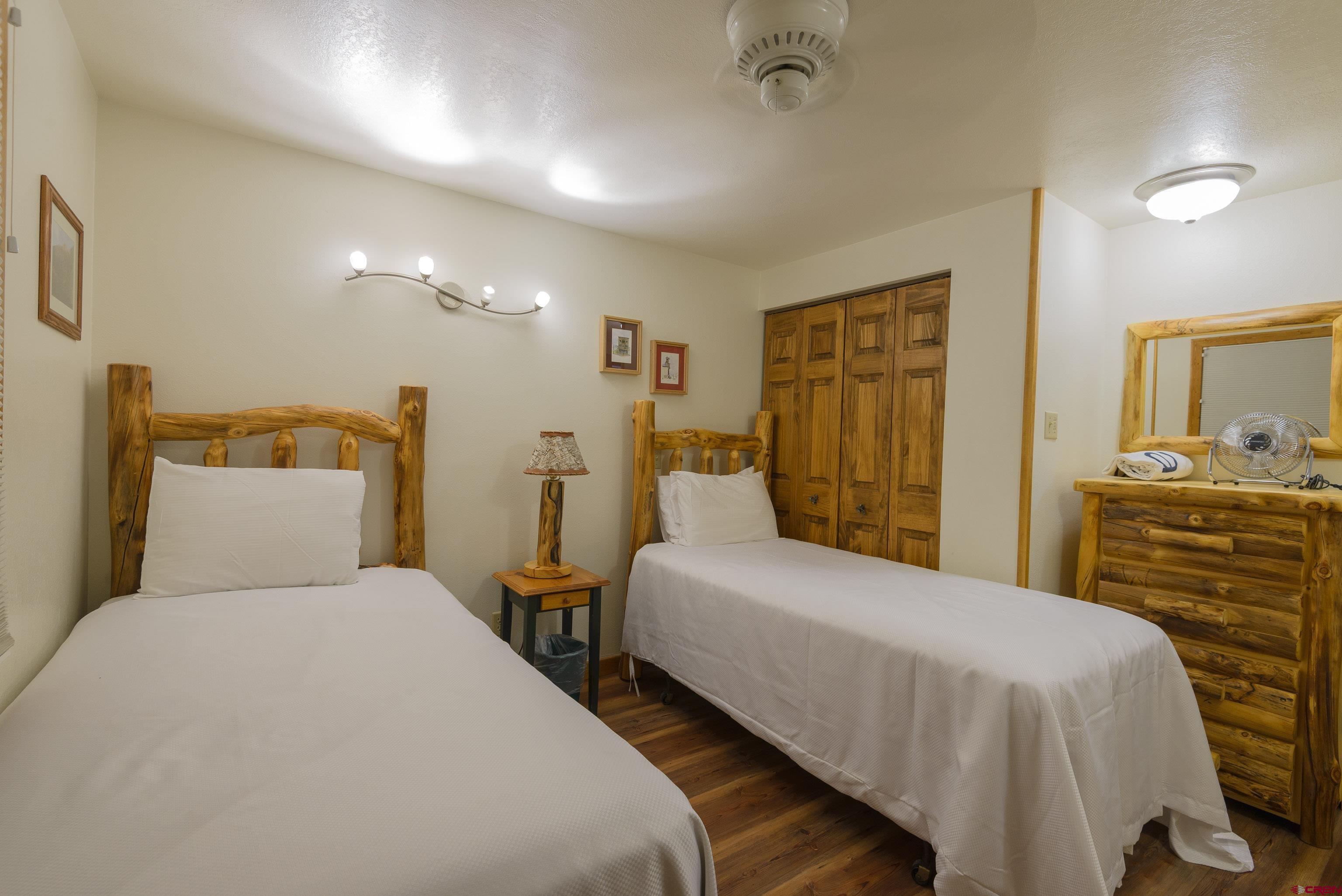 701 Gothic Road, Unit 332 Crested Butte, CO 81225 - Photo 4 of 29 a bedroom with a bed and wooden floor