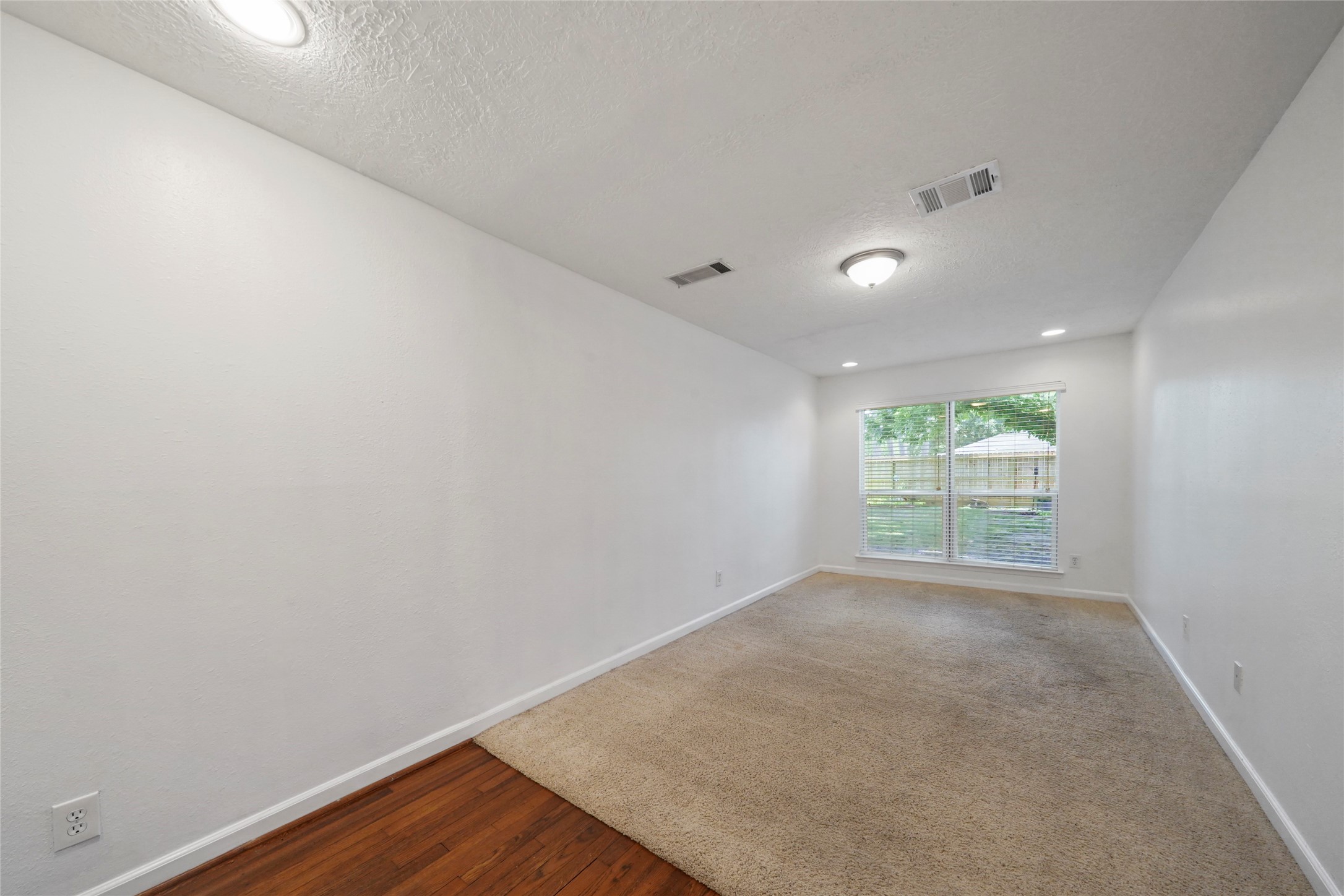 1803 Libbey Drive Houston, TX 77018 - Photo 27 of 44 Third bedroom has recessed lighting, wood floors
with carpet. Lots of room with a great view of the
backyard with double pane window.