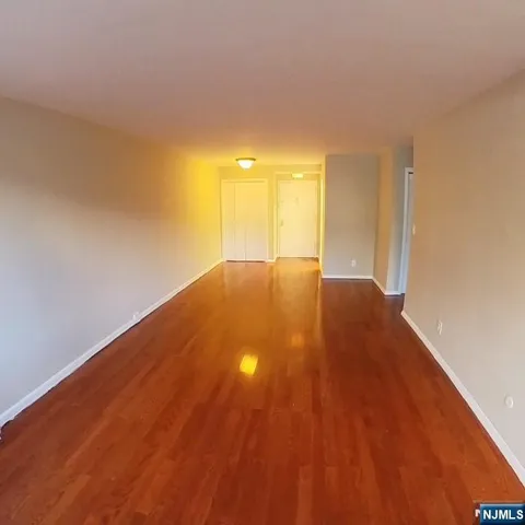 a view of an empty room and wooden floor