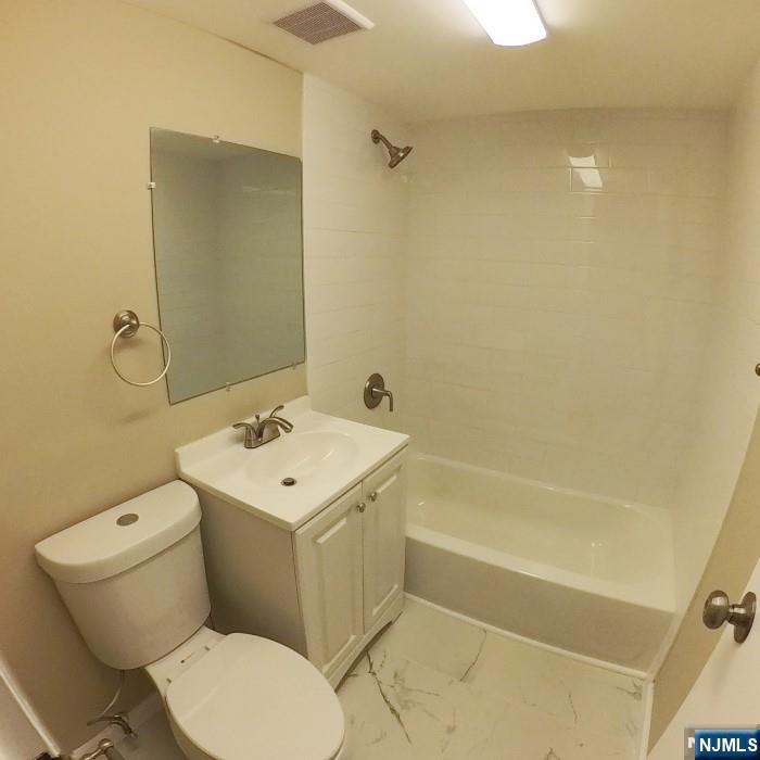 1600 Center Avenue, Unit 1D Fort Lee, NJ 07024 - Photo 8 of 10 a bathroom with a sink a toilet and shower