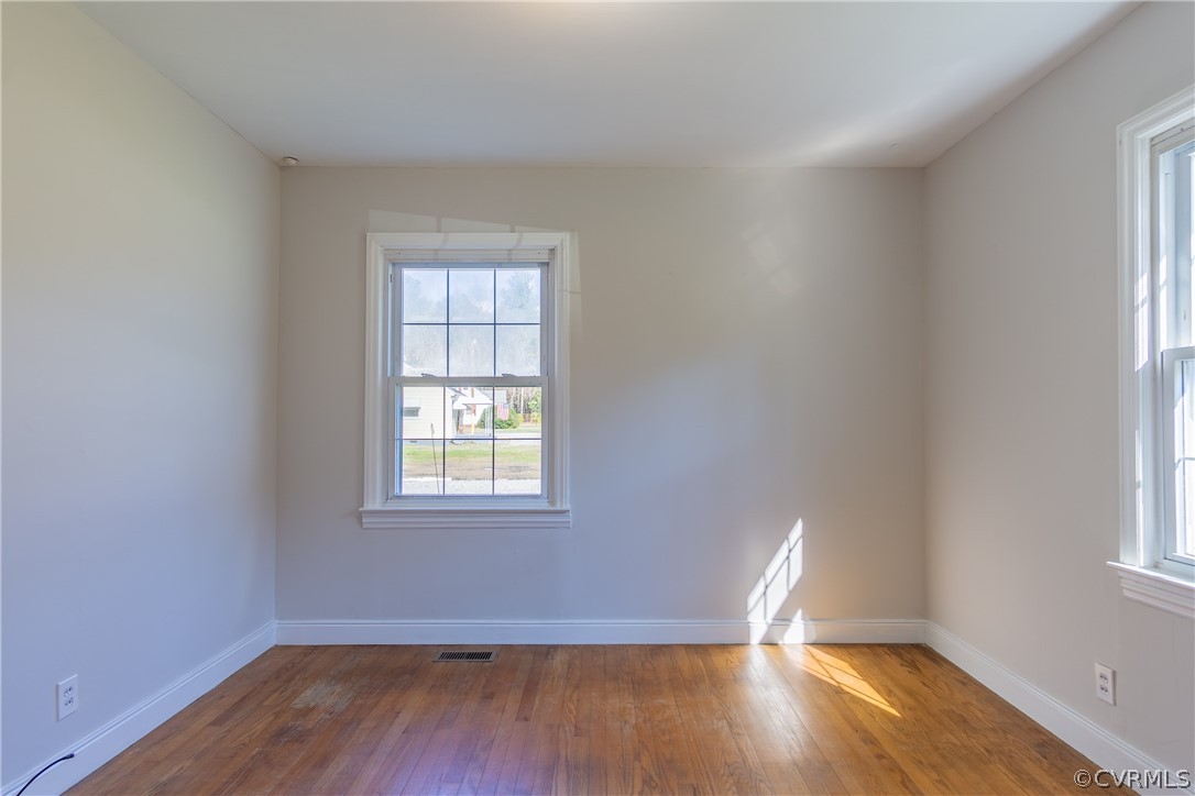8276 Varina Road Henrico, VA 23231 - Photo 19 of 39 an empty room with wooden floor and windows