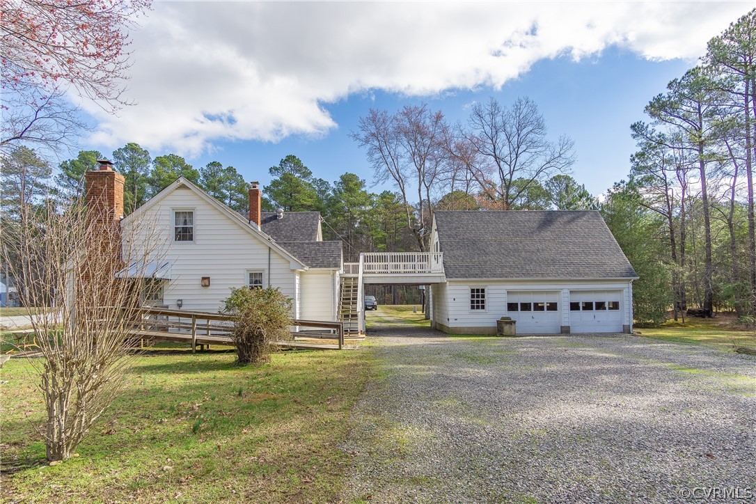 8276 Varina Road Henrico, VA 23231 - Photo 5 of 39 a view of a white house next to a yard with big trees