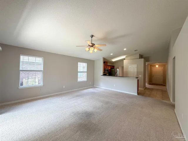 a view of a livingroom with a ceiling fan and window