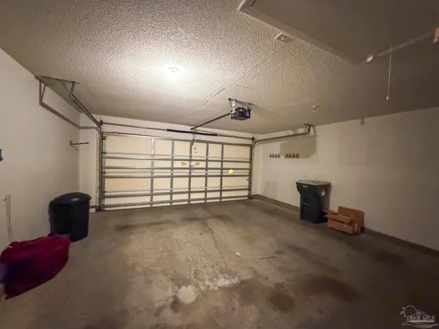 a view of a livingroom with a chair and a potted plant
